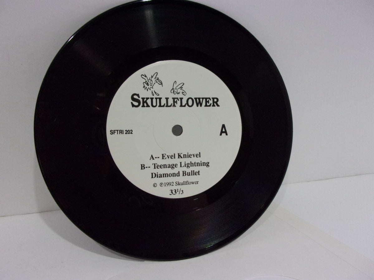 Skullflower: Evel Knievel SFTRI 202 7" single vinyl record label featuring tracks 'Evel Knievel' and 'Teenage Lightning' with Diamond Bullet.