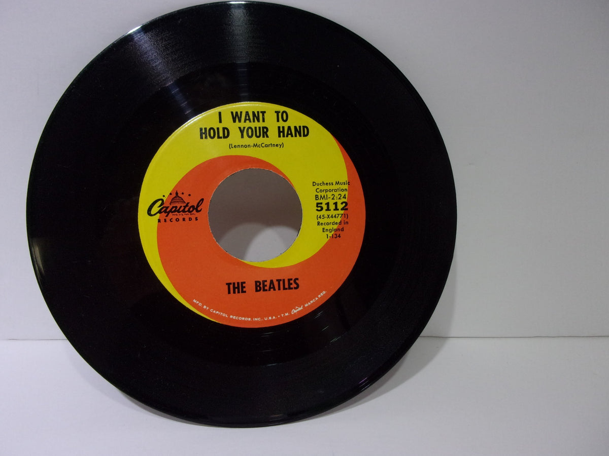 The Beatles: I Want To Hold Your Hand Capitol Records 5112 45RPM single showcasing the label with the song title 'I Want To Hold Your Hand'.