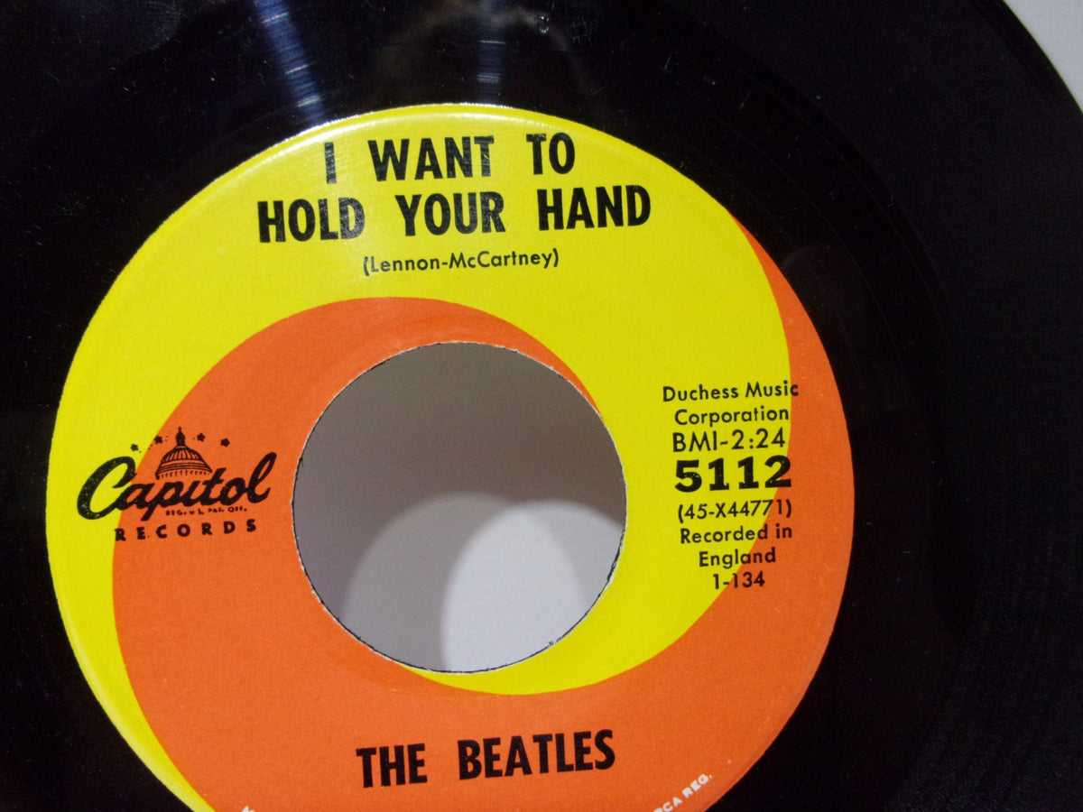 Close-up of The Beatles: I Want To Hold Your Hand Capitol Records 5112 45RPM single label displaying 'I Want To Hold Your Hand' and recording details.