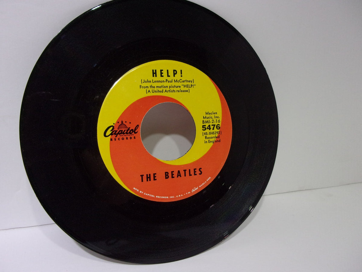 Close-up view of the vinyl record for The Beatles: Help! / I’m Down Capitol Records 5476, showing the label design.