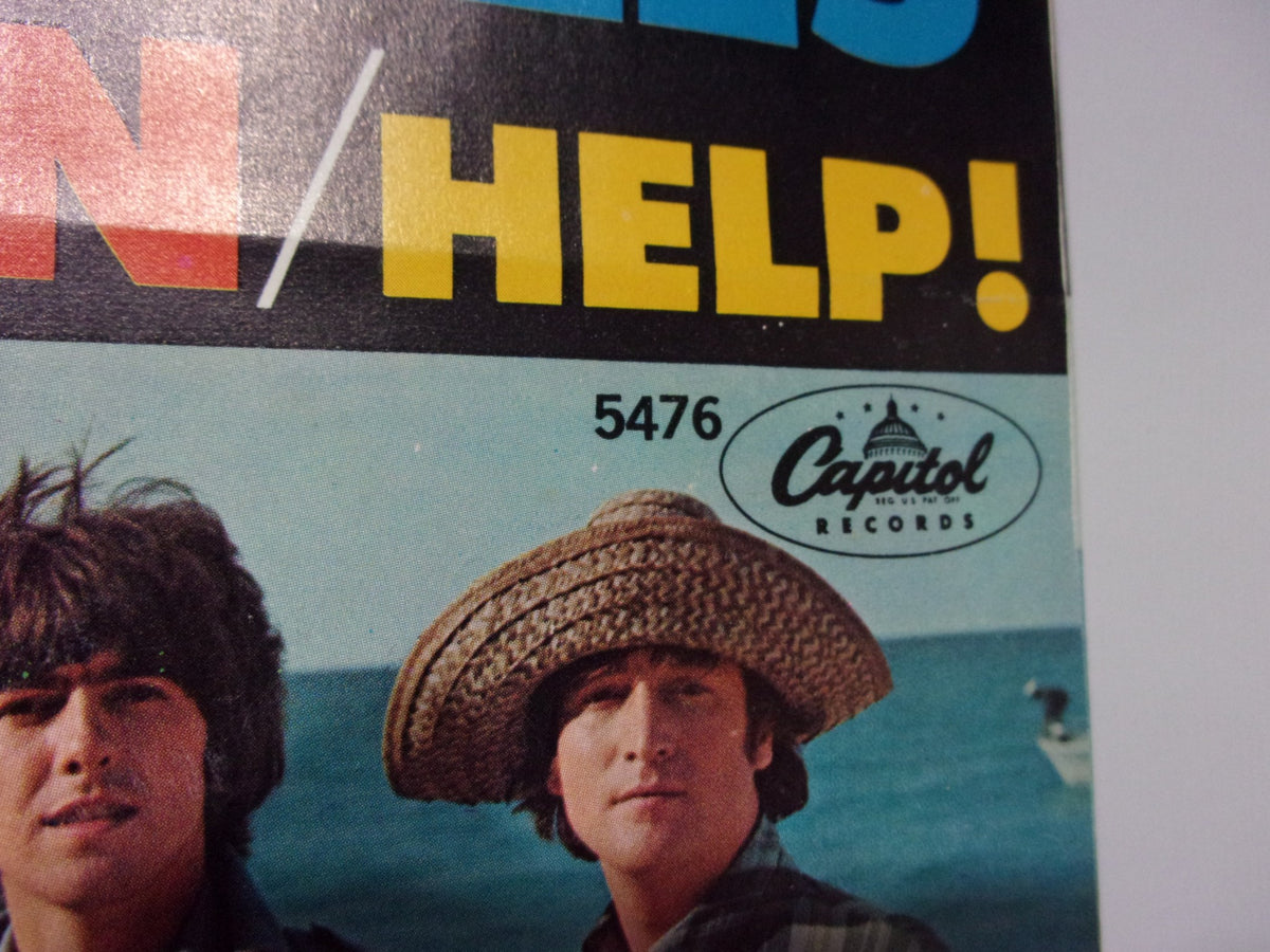 The Beatles: Help! / I’m Down Capitol Records 5476 Single cover showcasing the iconic logo and the title 'HELP!' with visuals of band members.