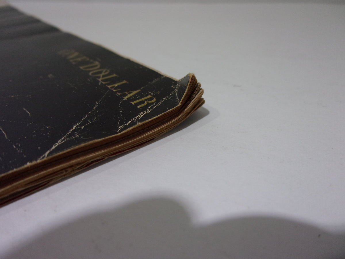 Close-up of the spine of the 1964 Look Magazine: JFK Memorial Book showing some wear and the price marking.