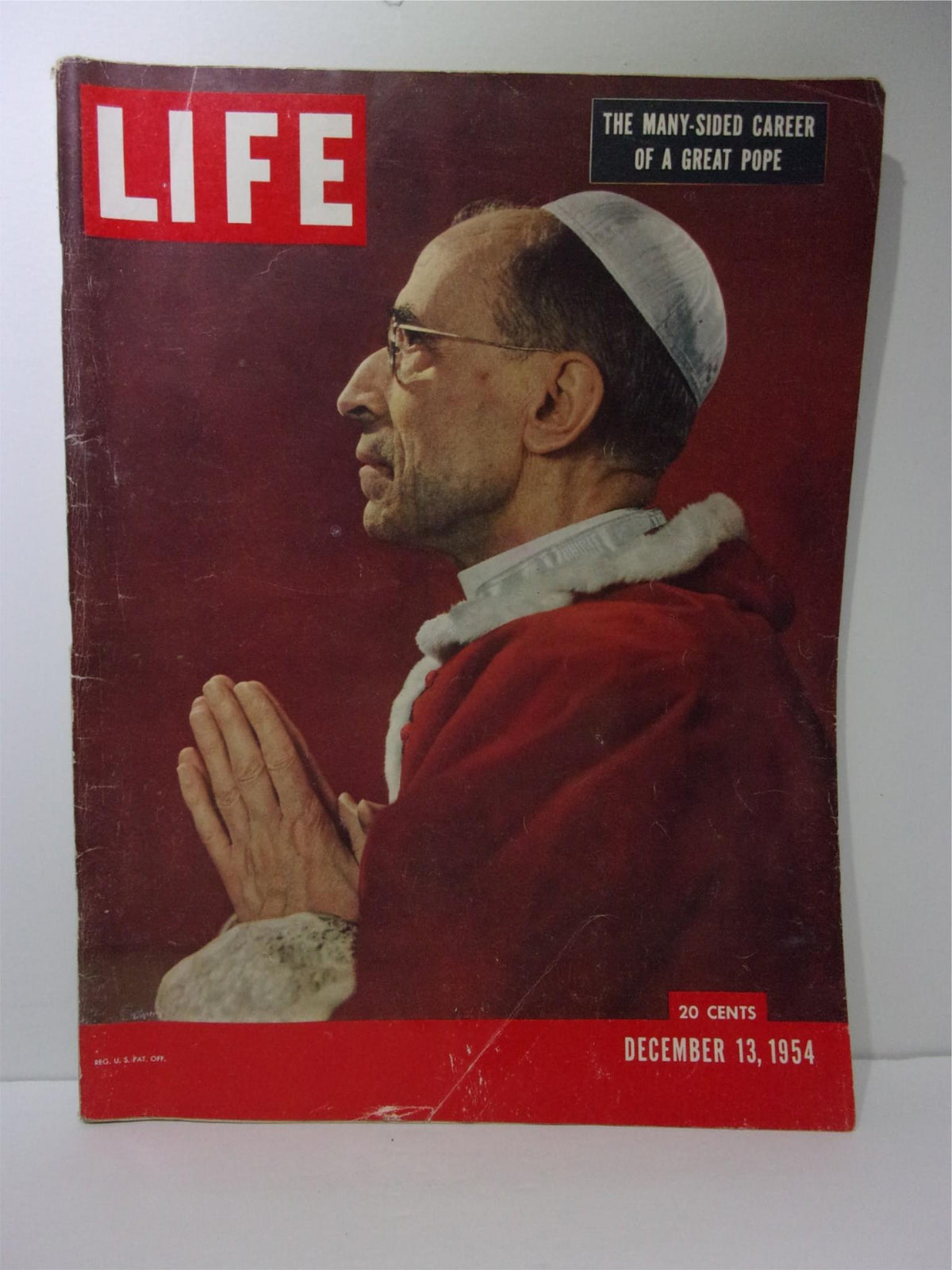 Life Magazine cover from December 13, 1954 featuring 'The Many-Sided Career of Pope Pius XII' with an image of Pope Pius XII in profile, dressed in papal robes, praying. This vintage publication highlights significant historical insights.