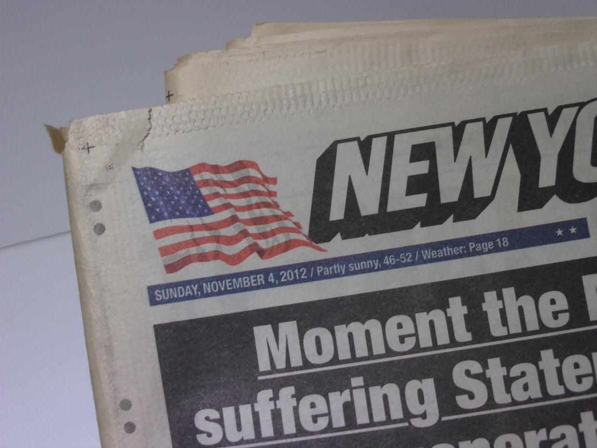 Top corner of the New York Post from November 4, 2012, showcasing the American flag and the date, relevant to the article discussing Staten Island's issues during the marathon.