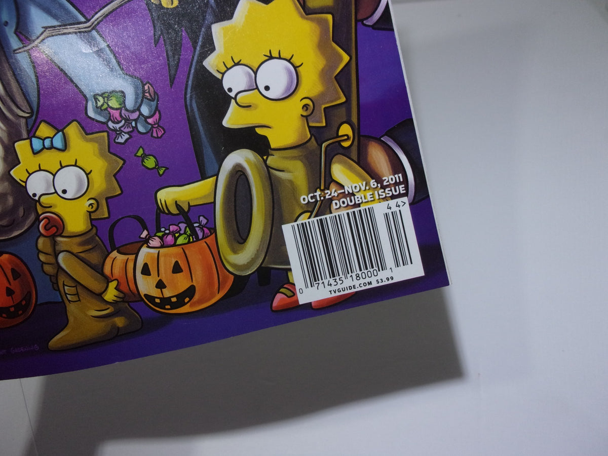 Back cover of TV Guide Oct 24-Nov 6 2011 Double Issue, displaying a barcode and featuring Lisa Simpson with a candy bag during Halloween.