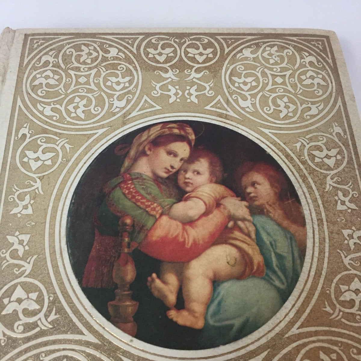 Close-up of the cover art from the Holy Bible Book The Christian Life Edition American Bible 1973 English, showing intricate designs and a depiction of a mother holding her child.