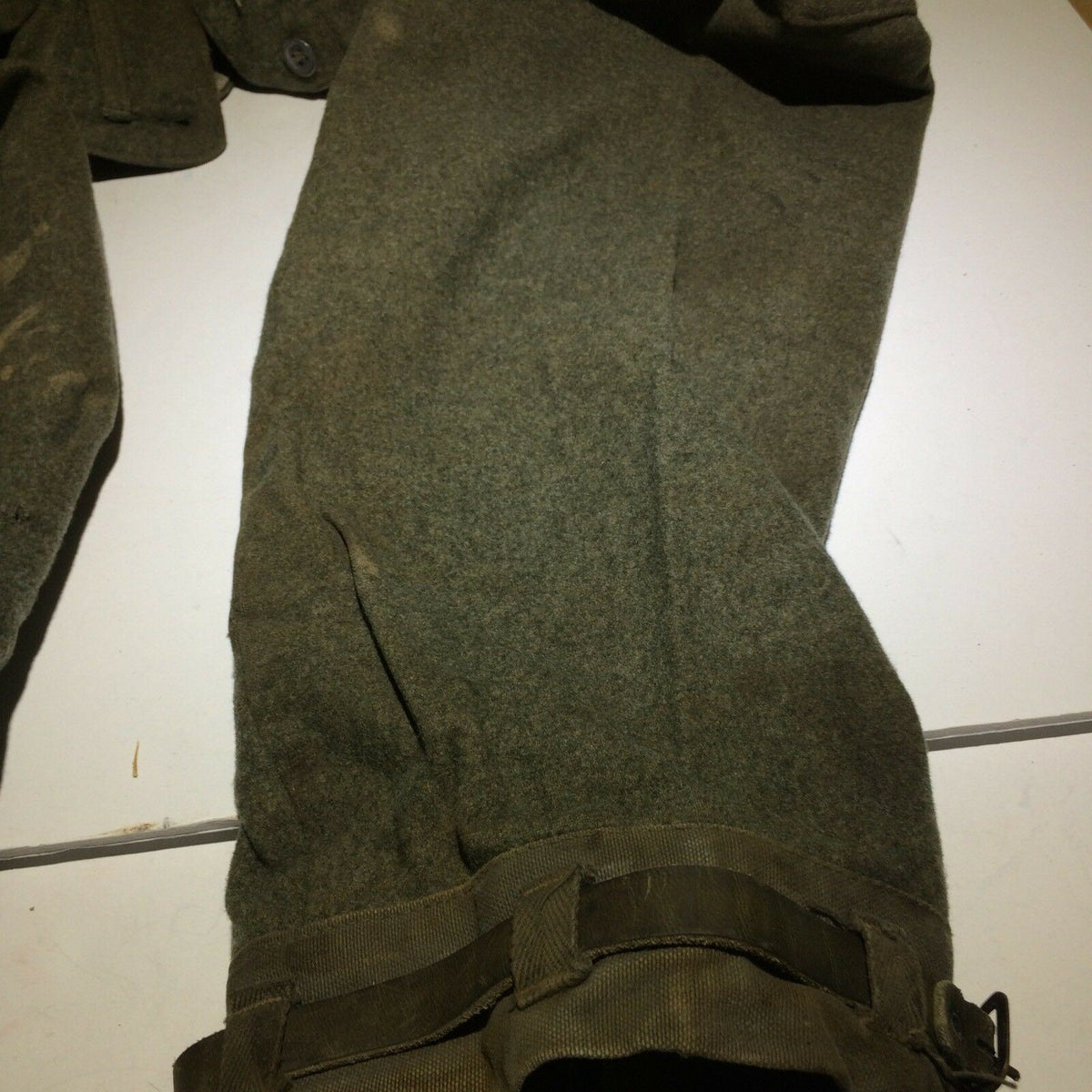 Side view of Vintage Swedish army military hunting cargo pants, illustrating the fit and design with straps.