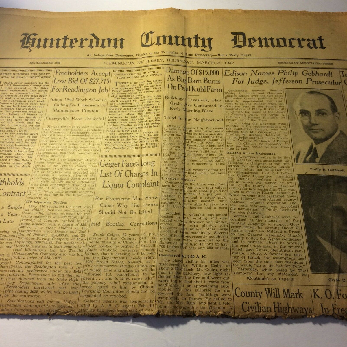 Hunterdon County Democrat newspaper from March 26, 1942, showing various news articles, headlines, and advertisements, with visible wear and tear from age.