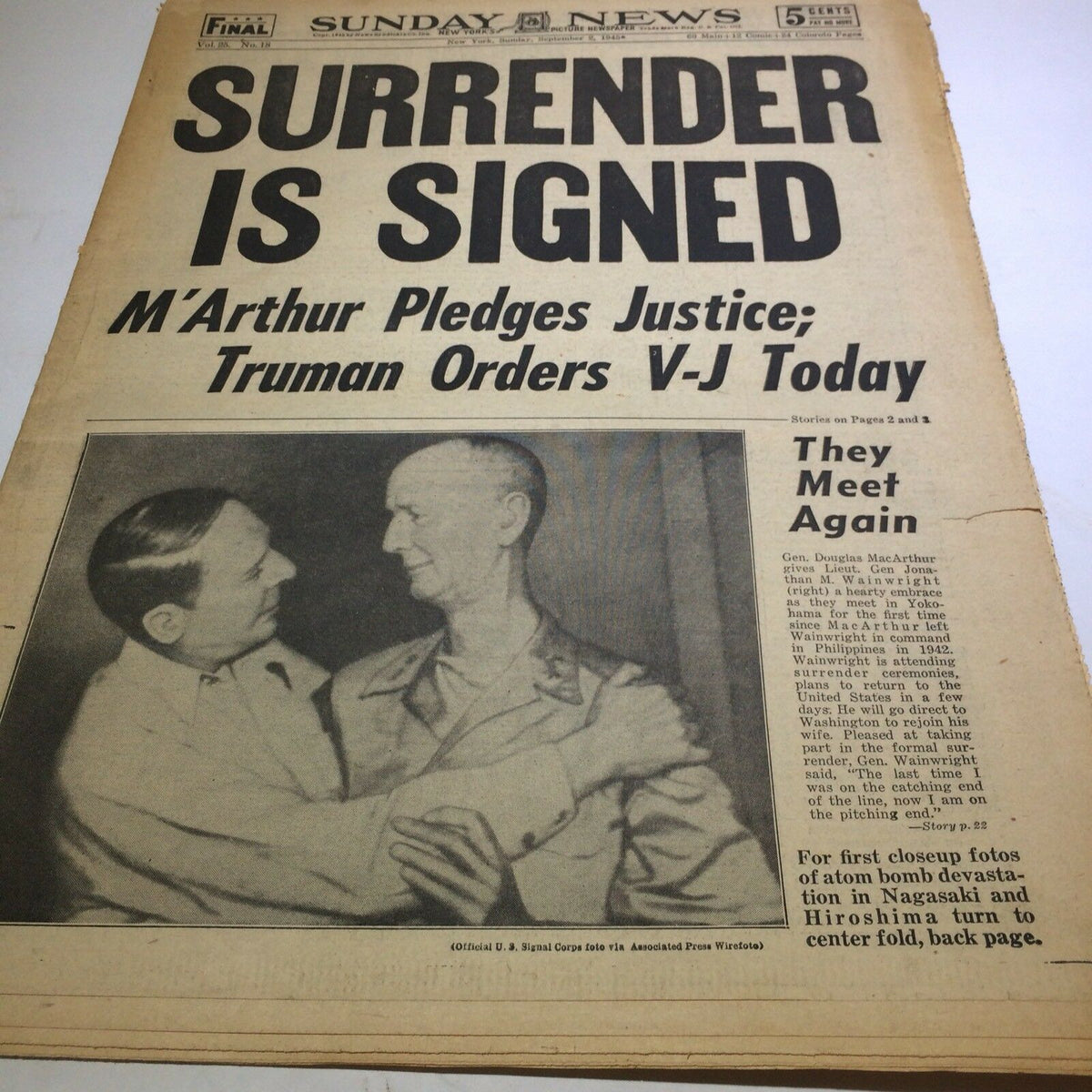 Vintage newspaper front page of the Sunday NY News, September 2, 1945, titled 'Surrender is Signed'. The page features headlines about General MacArthur and President Truman regarding V-J Day.