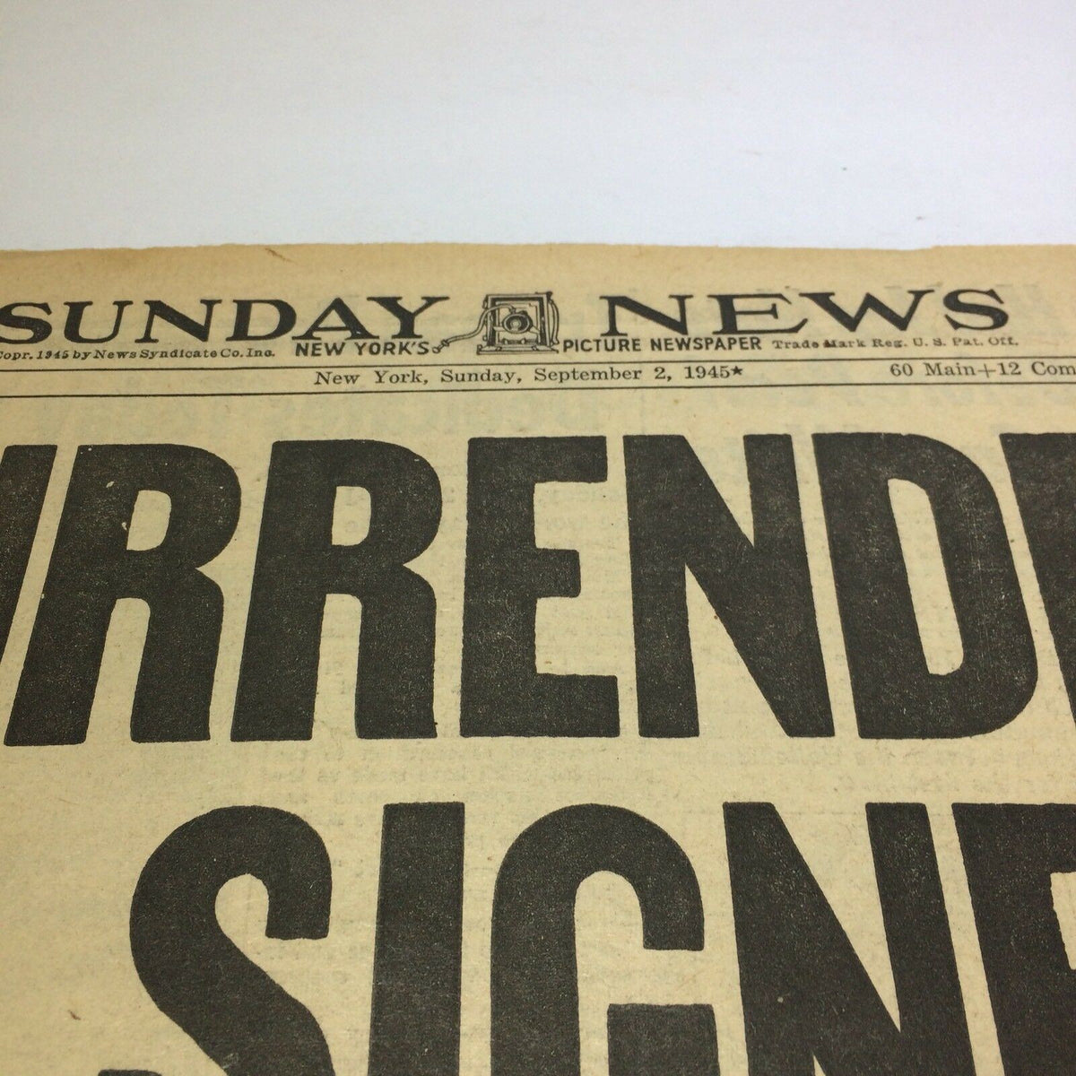 Top section of the Sunday NY News newspaper dated September 2, 1945, highlighting the title 'Surrender is Signed'. An original publication marking the historic day of the Japanese surrender.