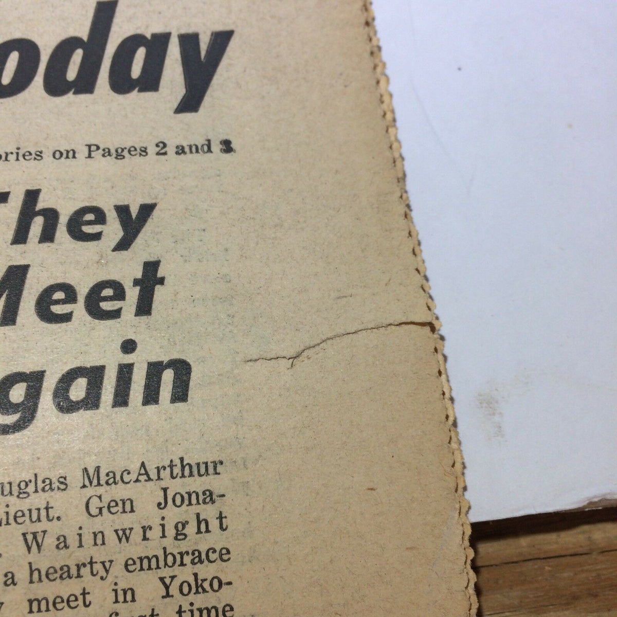 Close-up view of the Sunday NY News newspaper from September 2, 1945, focusing on the subheading 'They Meet Again', discussing the meeting of Generals MacArthur and Wainwright.