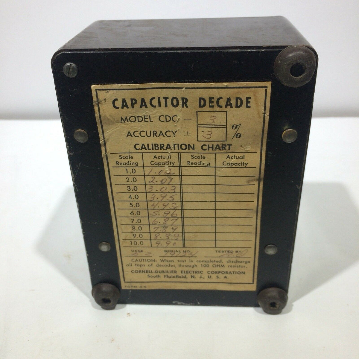 Cornell Dubilier Decade Capacitor Model CDC3 SN 19124 showing the calibration chart and specifications on the back side, designed for high voltage applications.