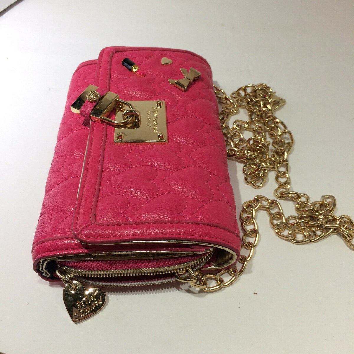Exterior view of Betsey Johnson Pink & Gold Chain Purse Bag Quilted Heart Lock Bow Lipstick featuring quilted texture and gold accents.