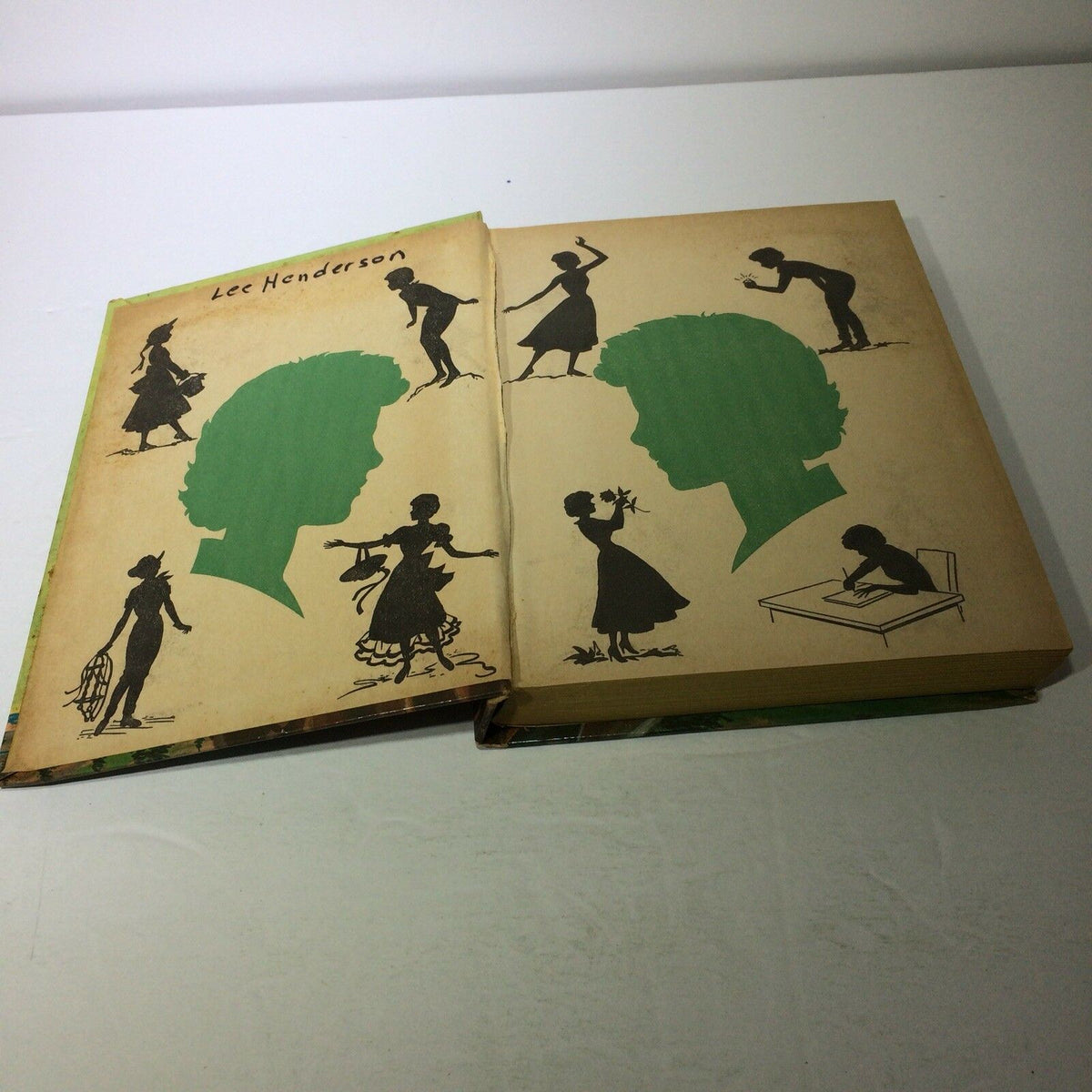 Interior spread of vintage Walt Disney's Annette Books featuring green silhouettes and illustrations on pages, highlighting the nostalgic design of 'Sierra Summer' and 'Mystery at Moonstone Bay'.