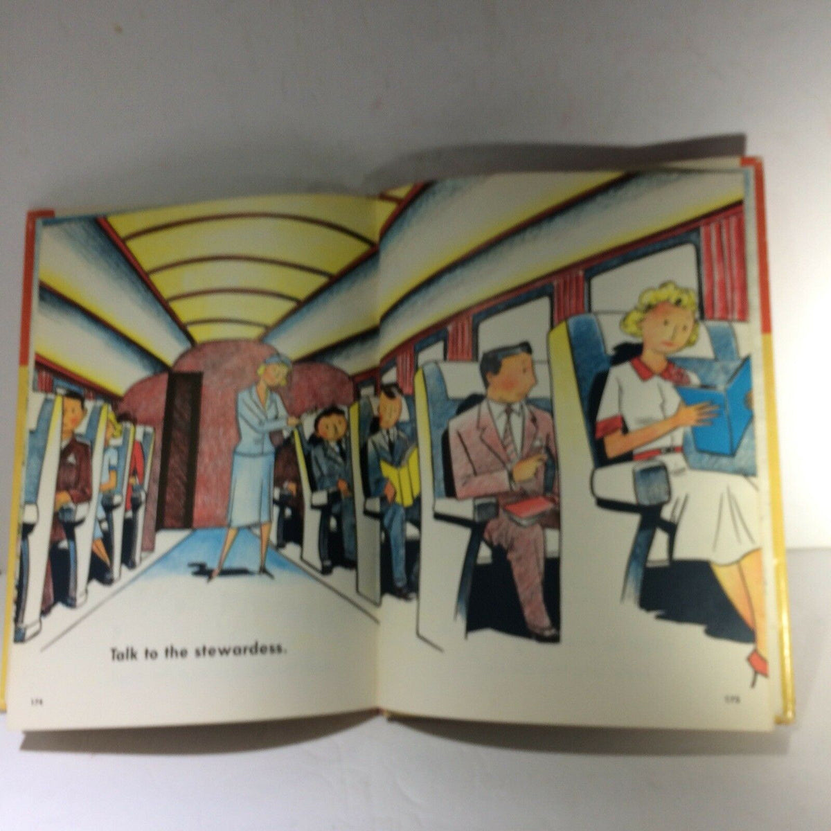 Illustrated page from The Giant Nursery Book of Things That Go by George Zaffo showing a train interior with passengers and a stewardess.