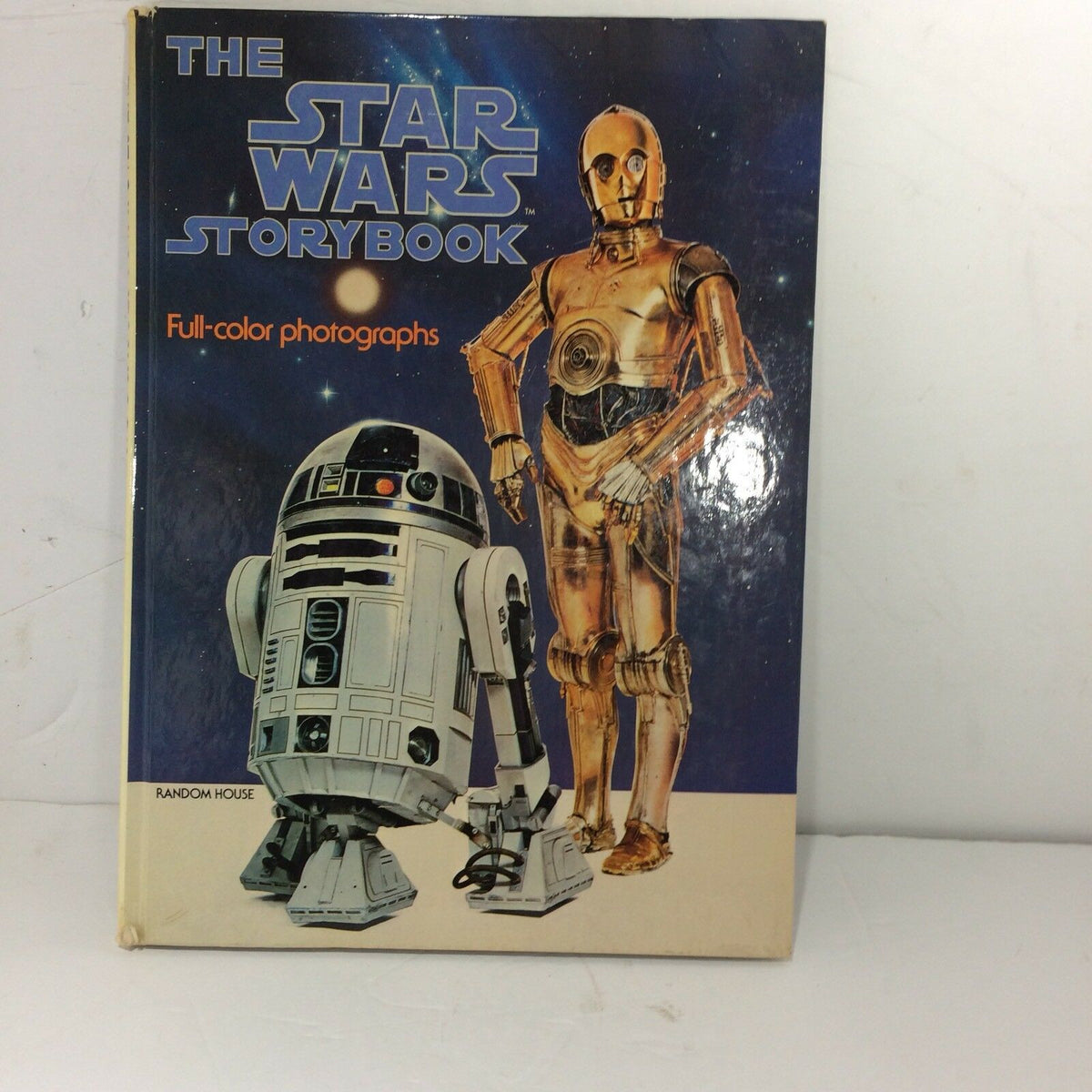 THE STAR WARS STORYBOOK hard cover edition featuring R2-D2 and C-3PO on the front cover, showcasing full-color photographs from the iconic 1978 movie, published by Random House.