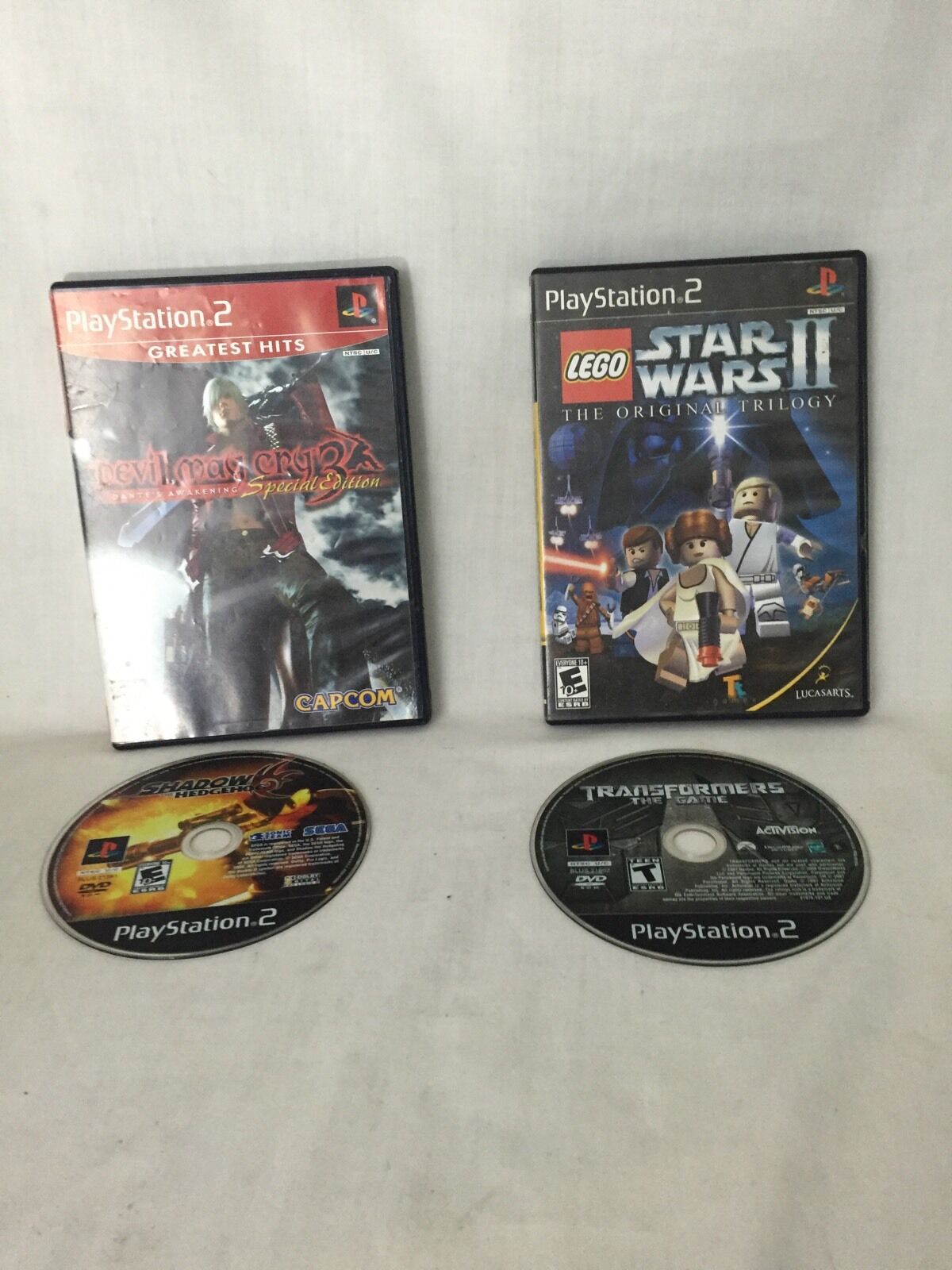 PlayStation 2 game covers for Devil May Cry 3 and Lego Star Wars II, featuring the titles from the collection 4 Devil May Cry 3 Dante's Awaken Transformers Shadow Hedgehog Lego star wars Ps2.