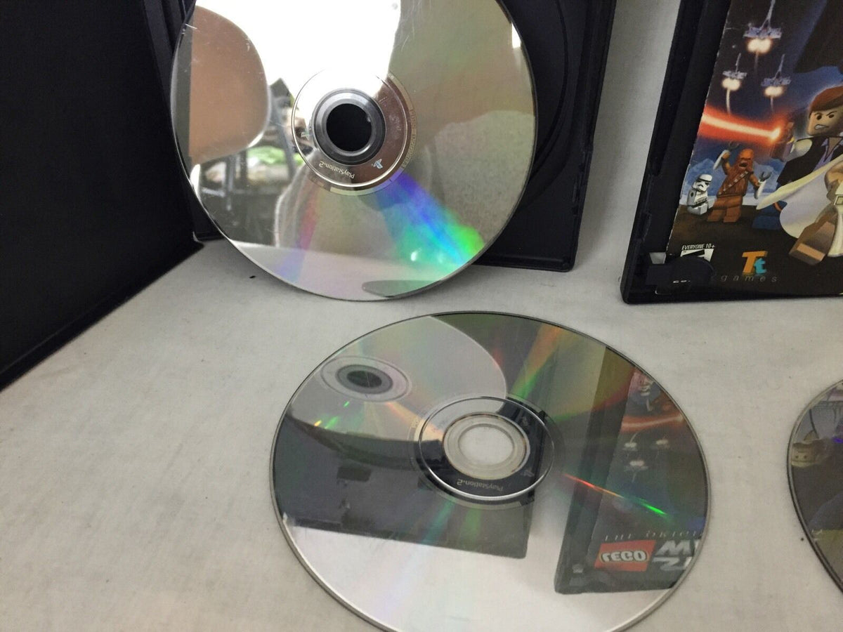 Close-up view of LEGO Star Wars game discs highlighting their reflective surfaces, featured in the 4 Devil May Cry 3 Dante's Awaken Transformers gaming collection.