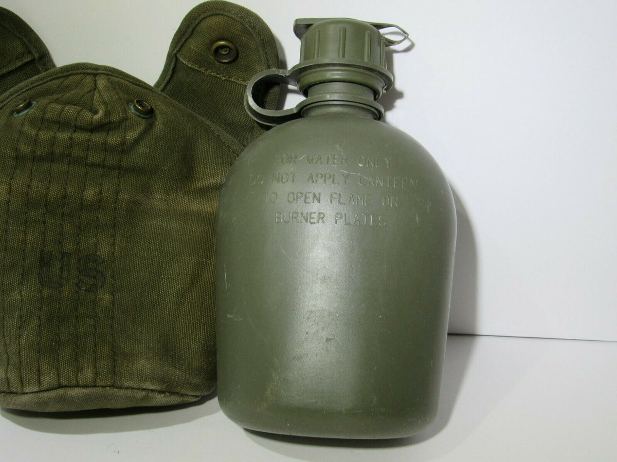 Vintage US Military Issue Vietnam Style War Era Canteen with Nylon Cover, featuring a classic military design and functionality, ideal for collectors and history enthusiasts.
