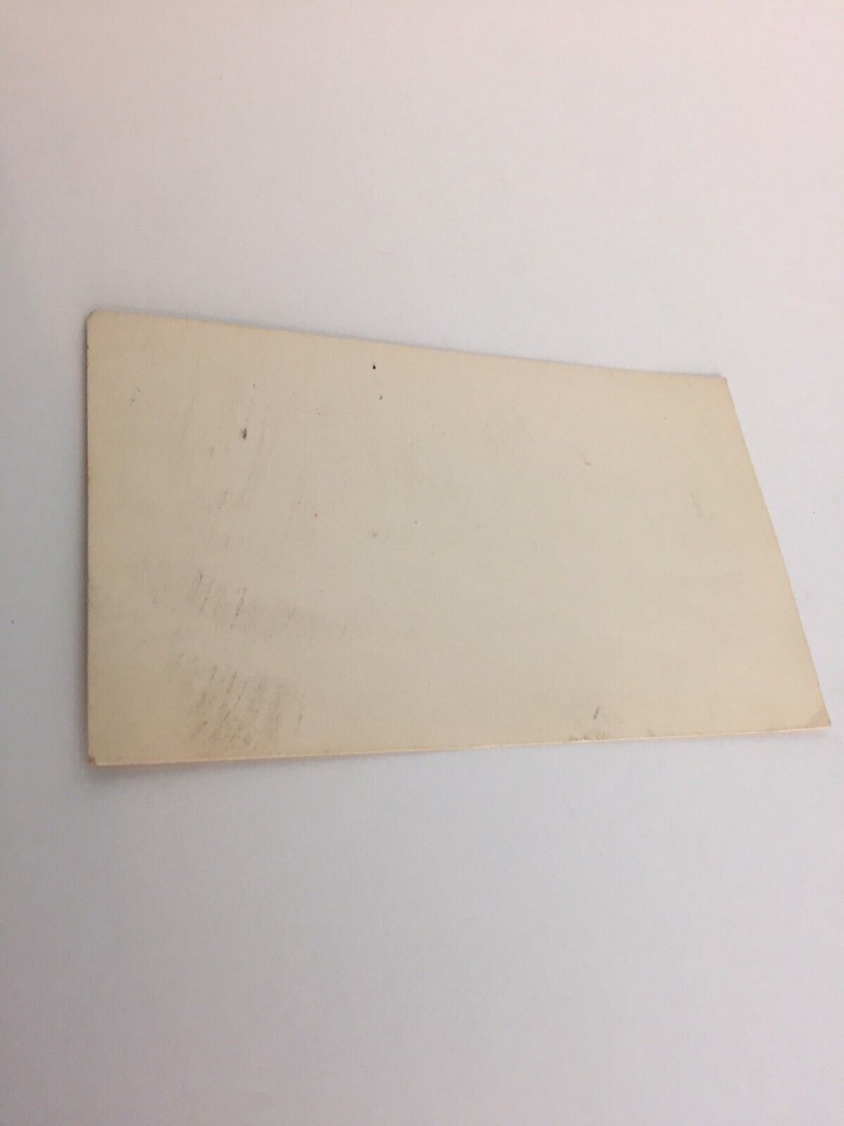Image showcasing the reverse side of a RARE 4 Cents Abraham Lincoln United States Postal Card, highlighting its blank, aged surface with subtle wear.