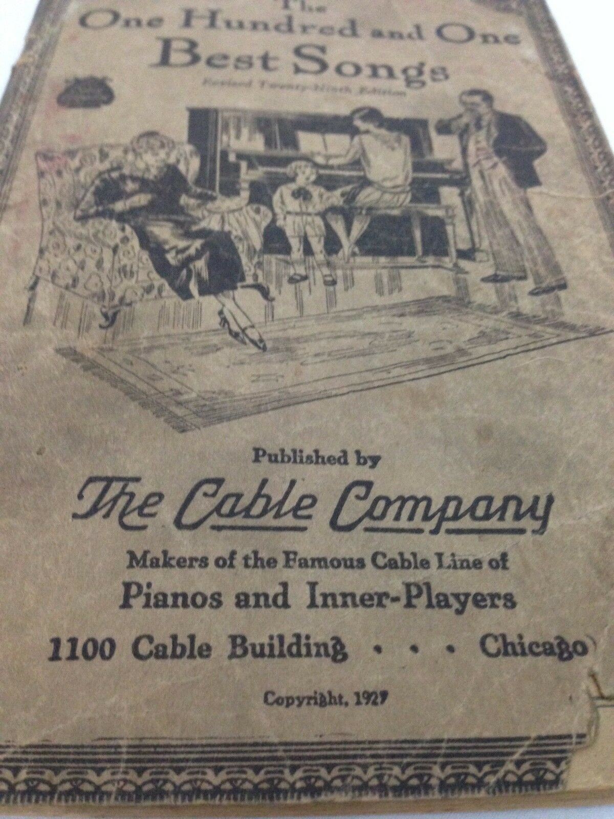 Detailed cover of The One Hundred and One Best Songs, 29th edition, 1927, highlighting The Cable Company and its connection to pianos and music.