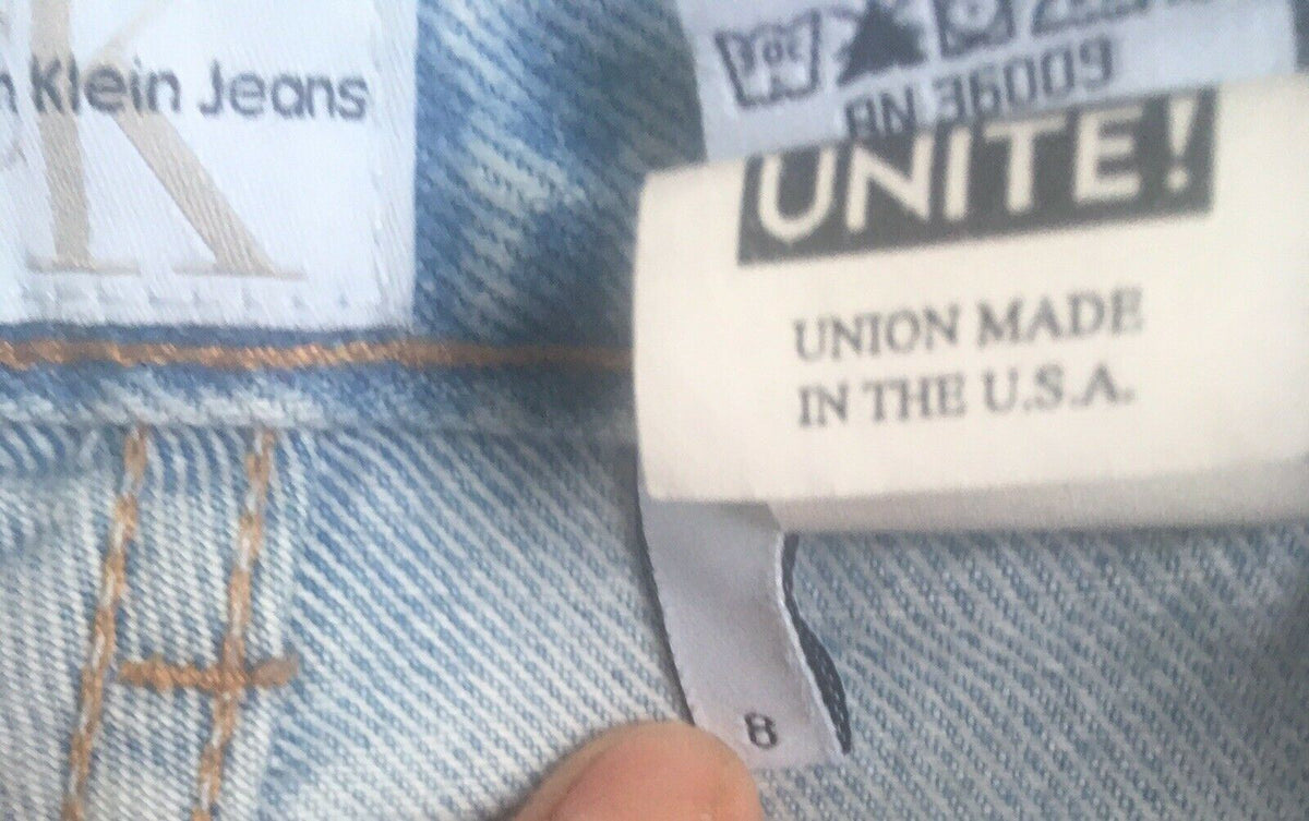 Label of Vintage 90s Calvin Klein High Rise Mom Jeans showing size 8 and 'UNITE! UNION MADE IN THE U.S.A.' tagging.