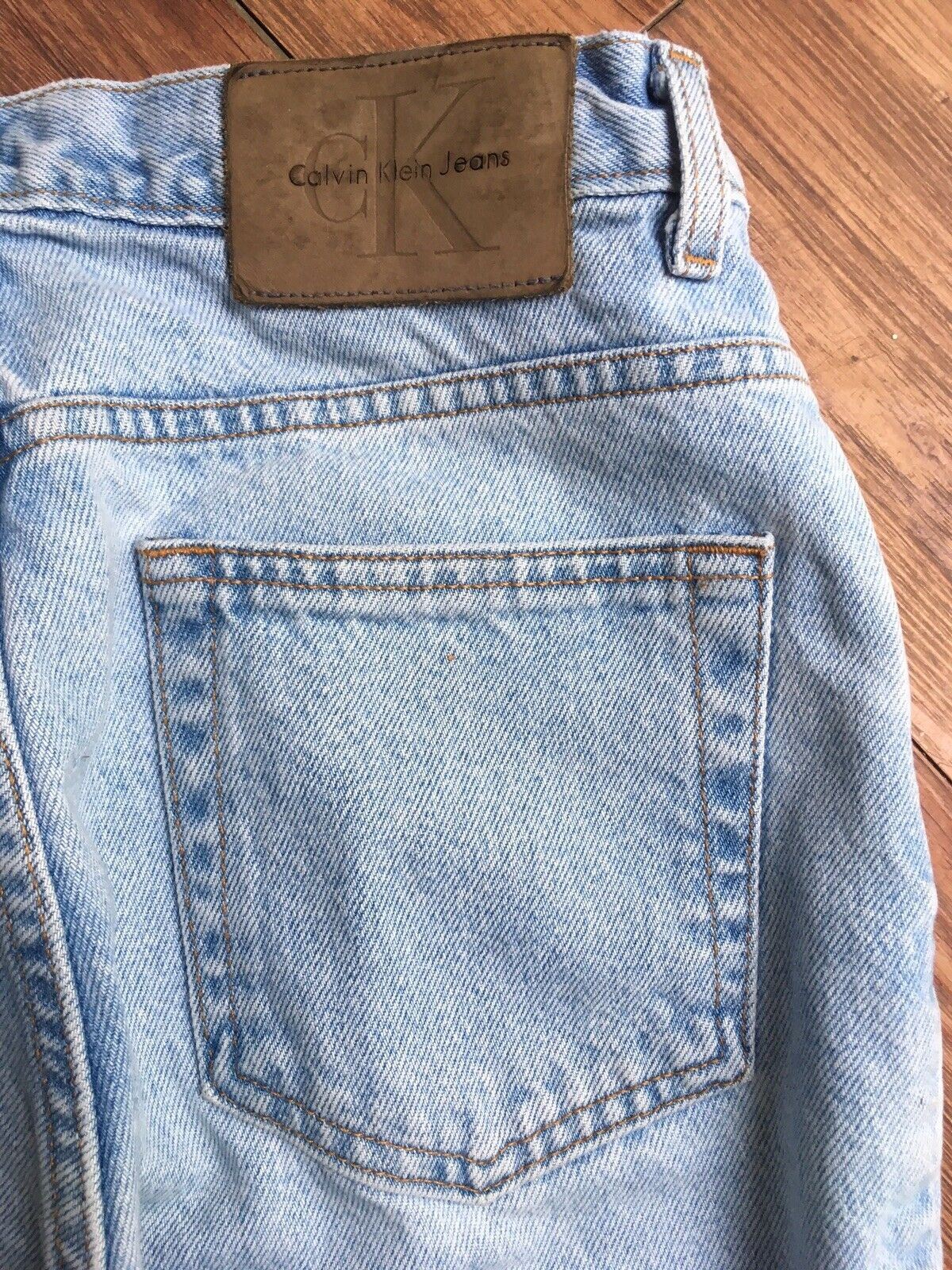 Close-up of the back waistband of Vintage 90s Calvin Klein High Rise Mom Jeans highlighting the leather tag.