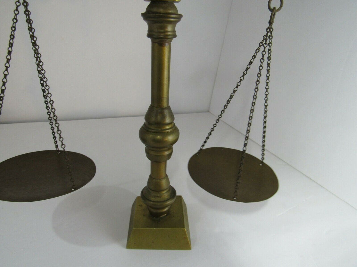 Base view of the vintage antique brass weight scale balance, featuring its sturdy support and chains.