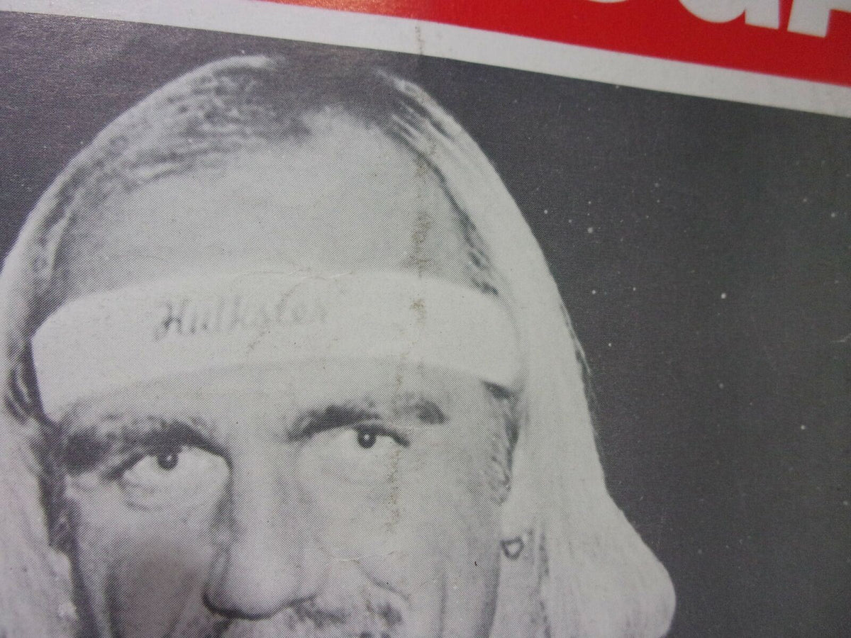 Black and white image of Hulk Hogan from the Special Tribute Hulk Hogan Magazine: Hulk - A - Mania Running Wild! showcasing his iconic headband and determined expression.