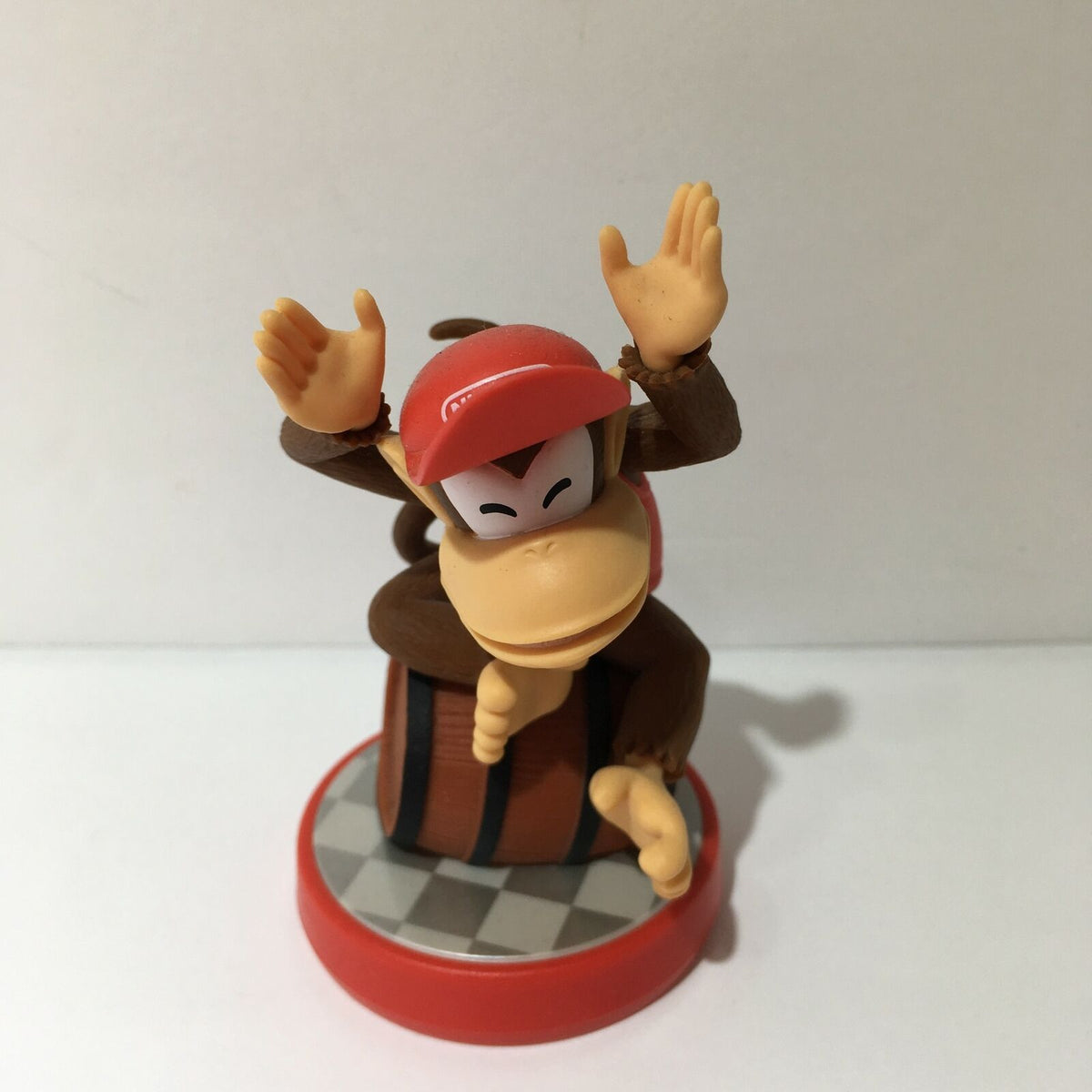 Nintendo Amiibo Diddy Kong figurine featuring Diddy Kong in a playful pose on a barrel base. Ideal for fans of Donkey Kong and Super Mario series.