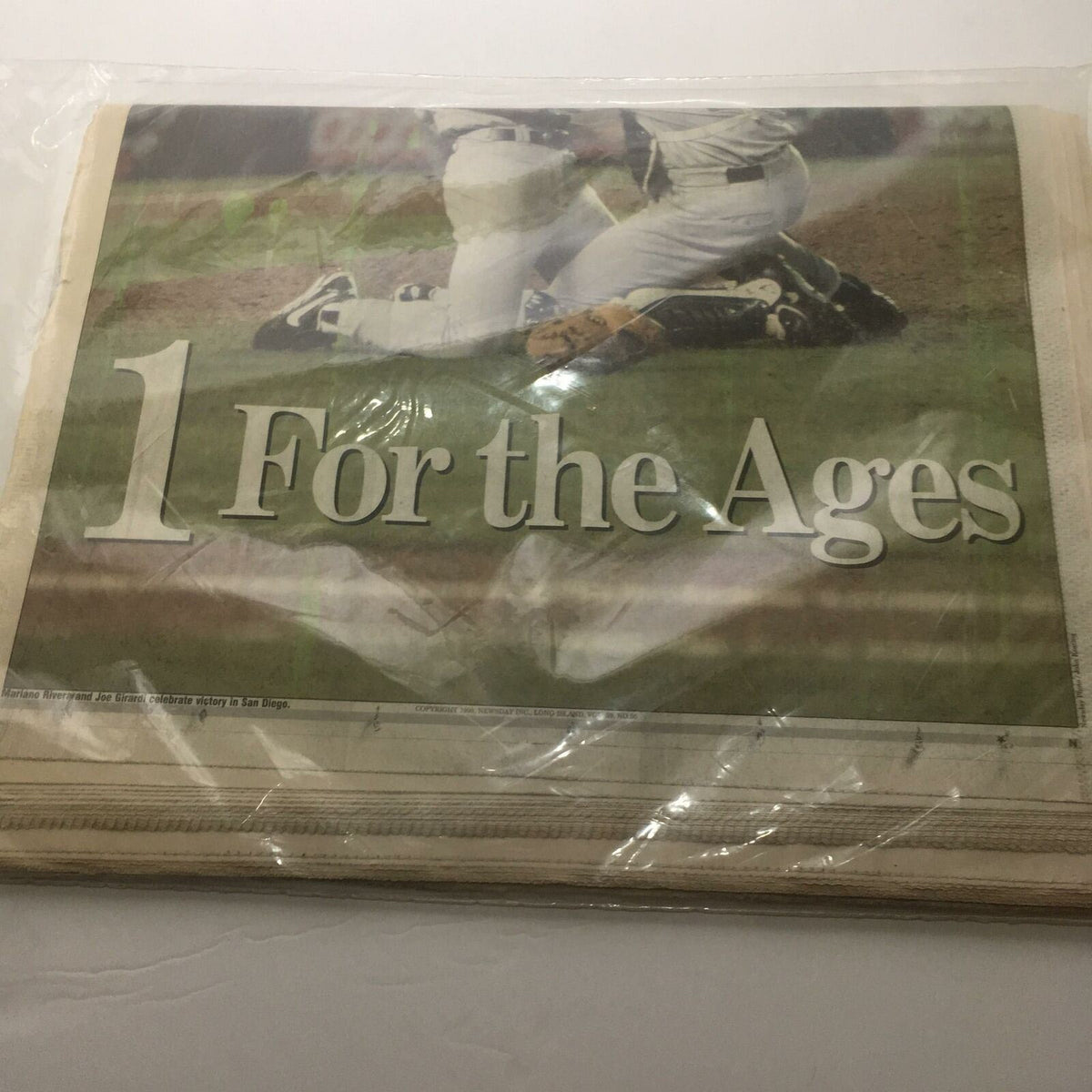 Detail from the front page of Newsday showing '1 For the Ages' related to the Yankees' historic win.