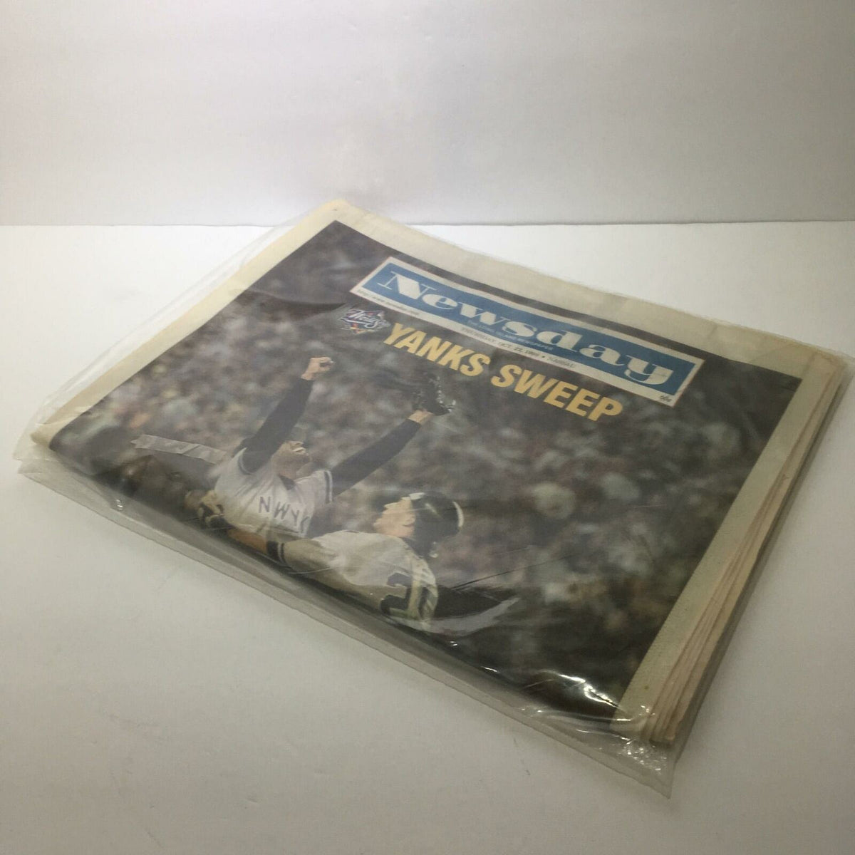 Newsday newspaper dated October 22, 1998, featuring the headline 'Yanks Sweep' celebrating a significant achievement in baseball, presented in a protective plastic cover.
