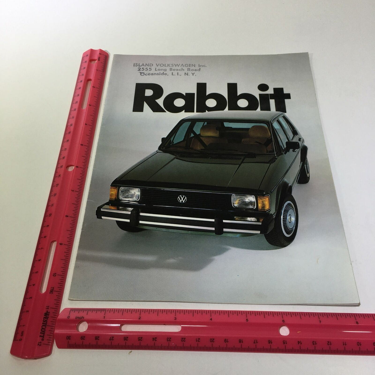 1982 Island Volkswagen Rabbit Fuel-Injected Engine 74 Horsepower Car Brochure featuring a front view of the vehicle, displayed on a white background with a ruler for size reference.