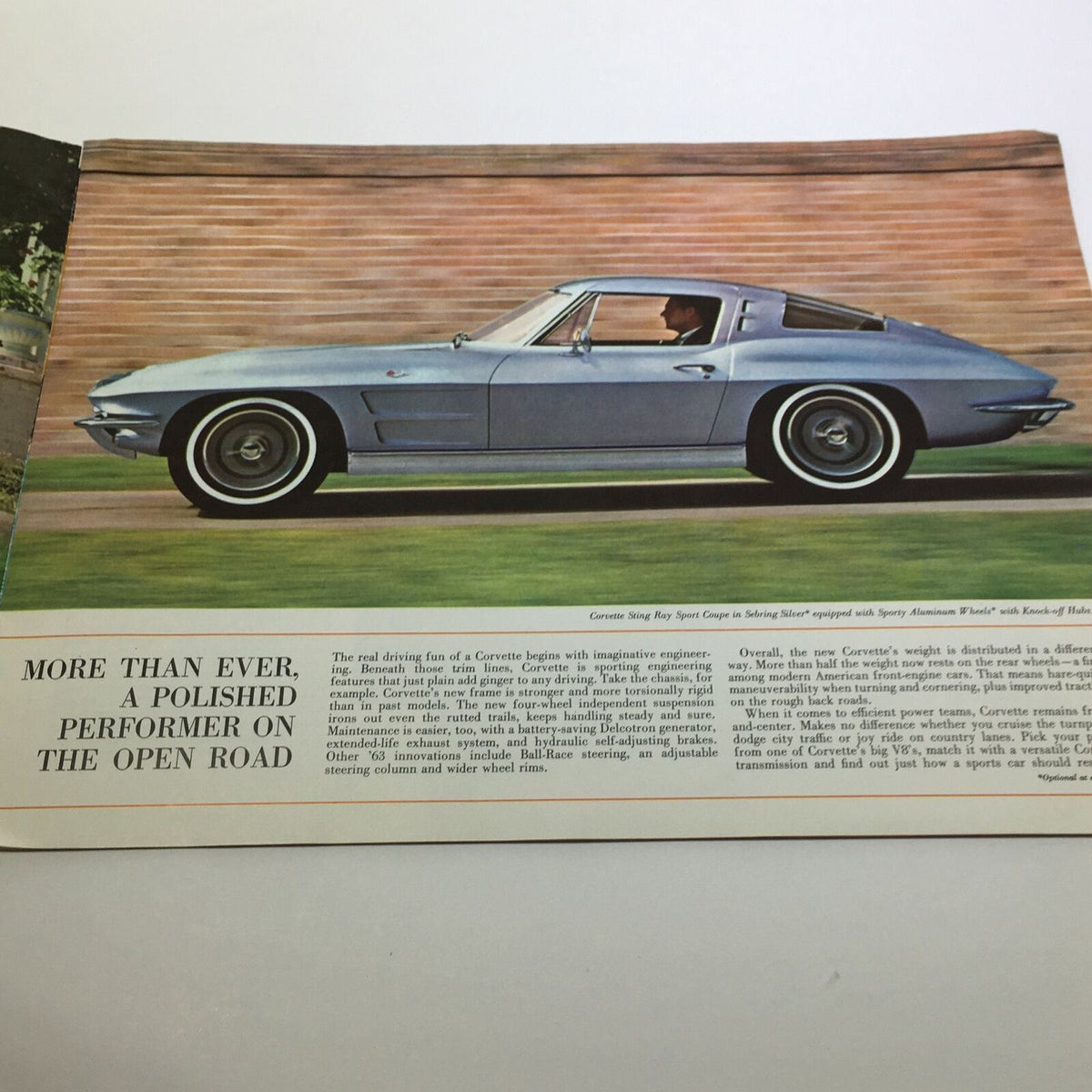 1963 New Corvette Sting Ray Sport Coupe Sale Brochure featuring a side view of a blue Corvette Sting Ray with elegant design details.