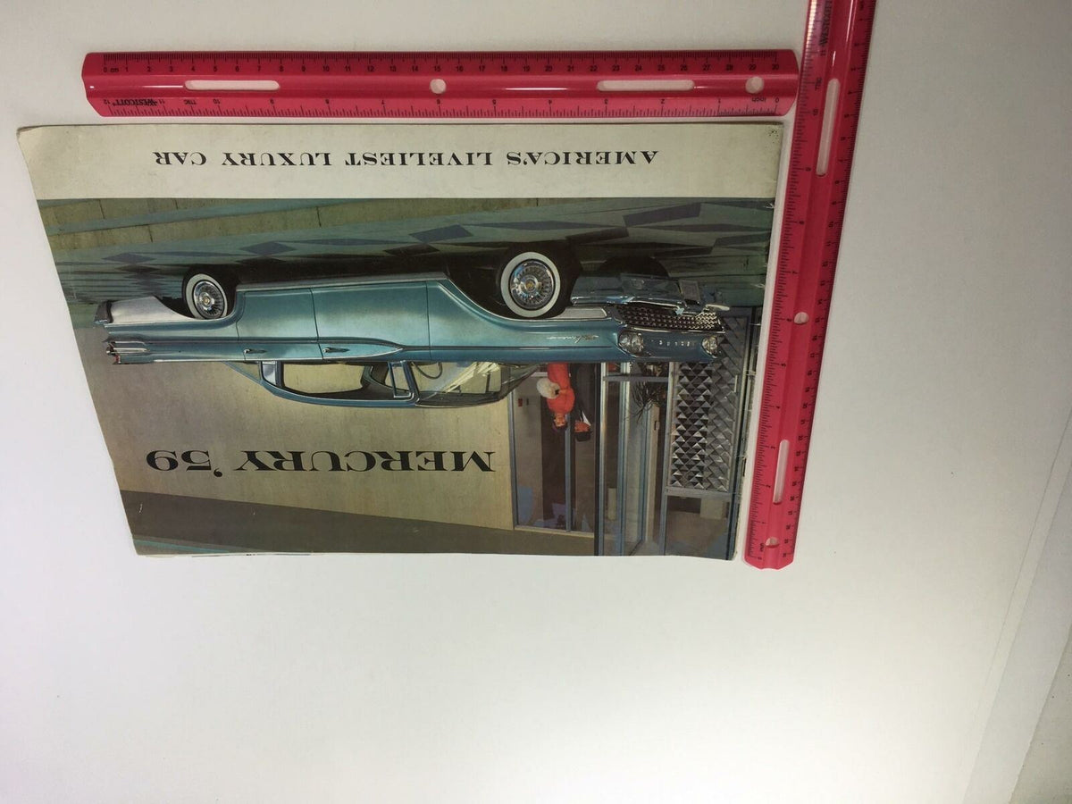 Another view of the 1959 Mercury America's Liveliest Luxury Car Monterey 2-Door Sedan Car Brochure, displaying the front of the brochure featuring the Mercury car with a ruler for scale.
