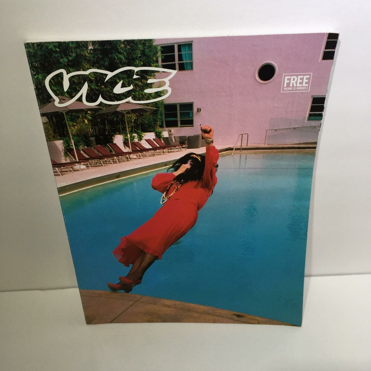 Cover of Vice Magazine: Free Volume 22 Number 2, featuring a woman in a vibrant red dress diving into a pool, embodying the bold and edgy aesthetic of counterculture.