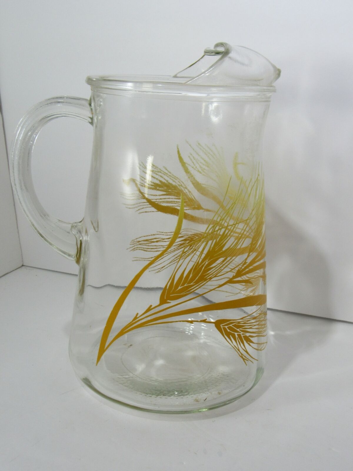 Vintage Libbey Golden Wheat Glass Pitcher with Ice Lip, showcasing golden wheat design on clear glass, 9 inches tall.