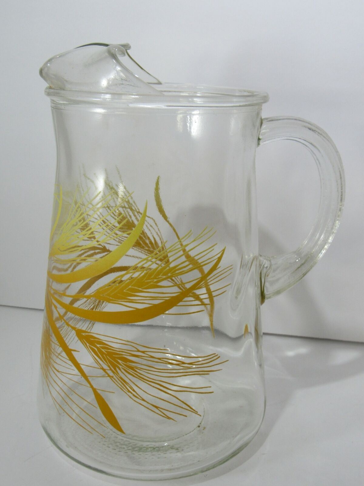 Side view of Vintage Libbey Golden Wheat Glass Pitcher with Ice Lip, highlighting its elegant shape and golden wheat pattern.