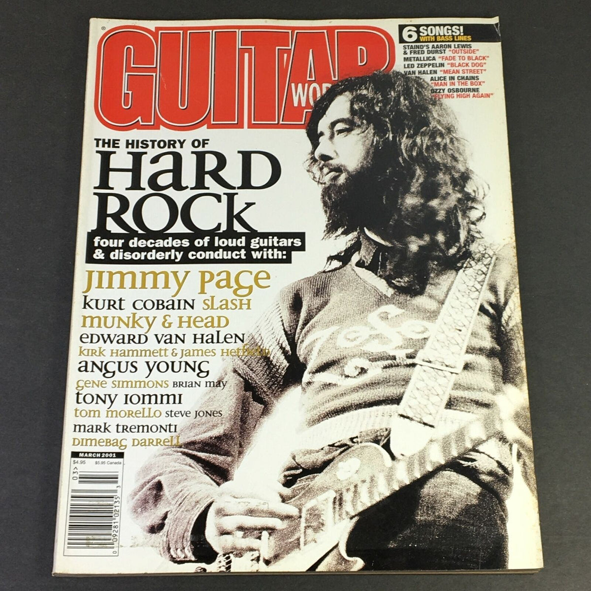 Guitar World Magazine March 2001 cover featuring Kurt Cobain, Edward Van Halen, and Angus Young, highlighting the history of hard rock and iconic guitarists.