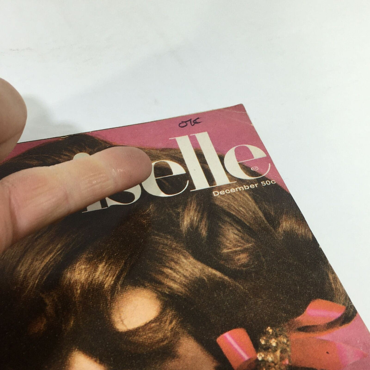 Close-up of the Vintage Mademoiselle Magazine cover from December 1967, focusing on the title and details of the model, reflecting 1960s chic fashion.