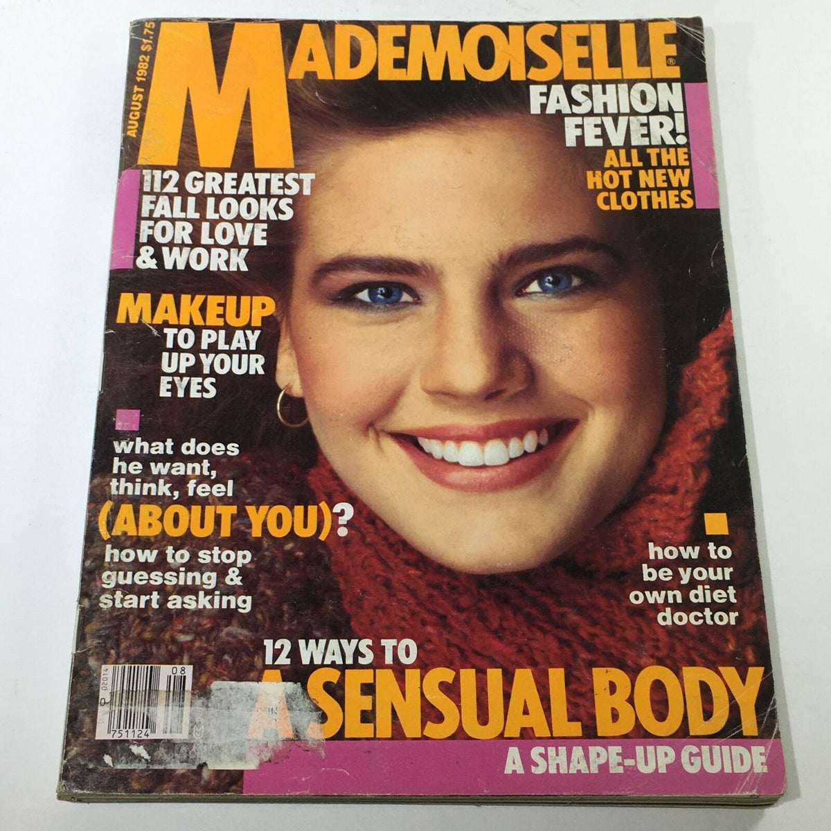 VTG Mademoiselle Magazine: August 1982 cover featuring a smiling model with bright blue eyes and styled hair, showcasing fashion trends and makeup tips for the 80s.