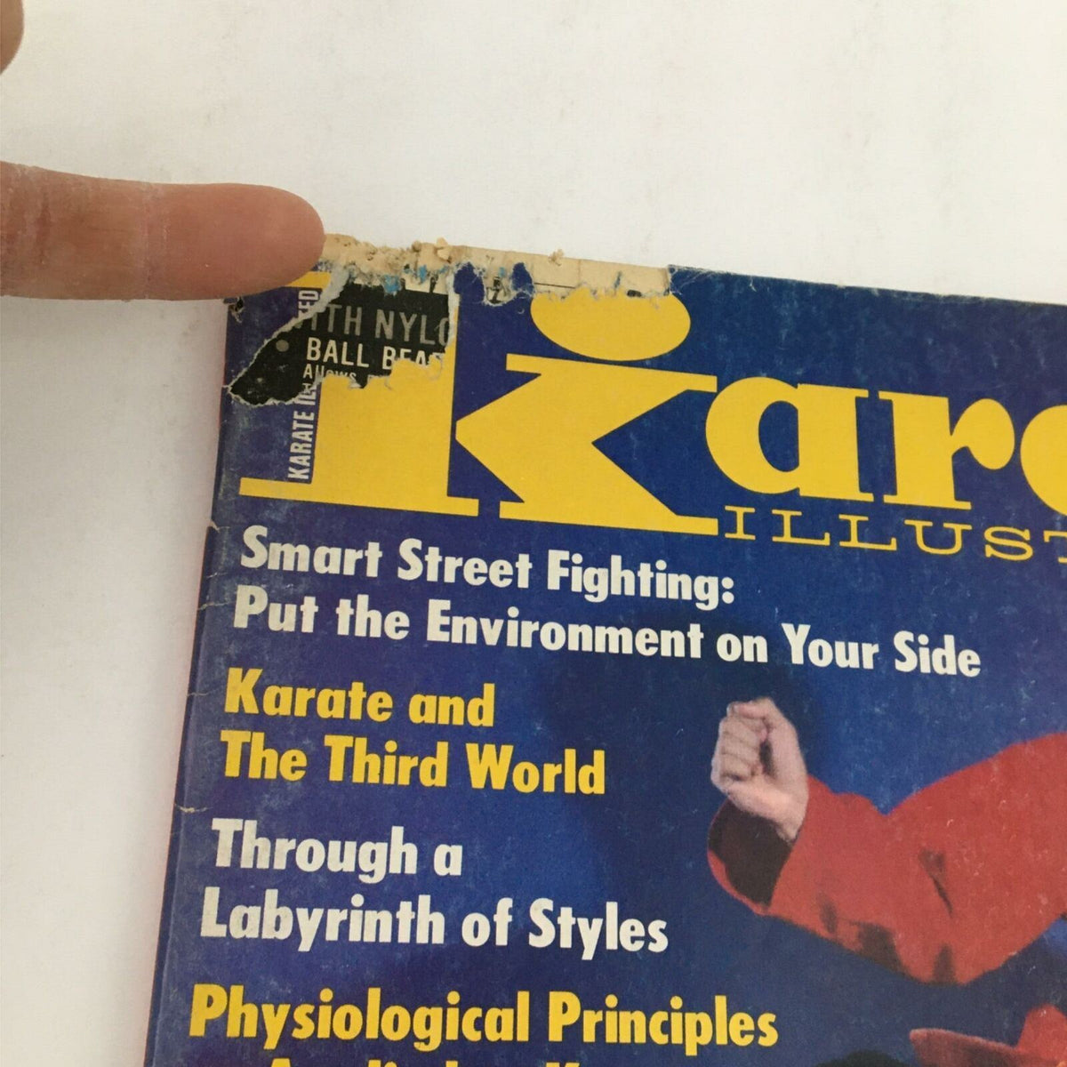 Close-up of the top portion of Karate Illustrated Magazine from December 1979, highlighting the title and contents such as 'Smart Street Fighting' and 'Physiological Principles as Applied to Karate'. Illustrates the magazine's importance in karate history.