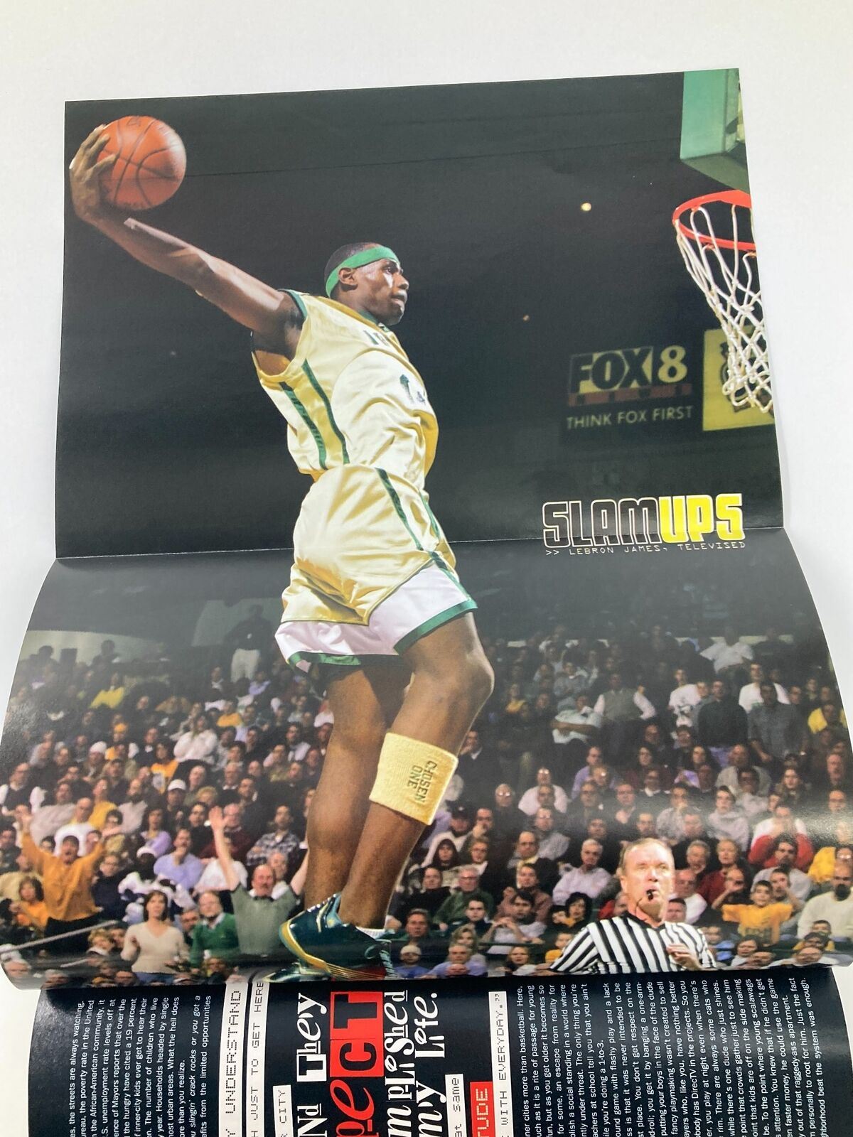 Slam Magazine April 2003 poster featuring a dynamic basketball dunk by Allen Iverson, showcasing his athleticism and iconic style.