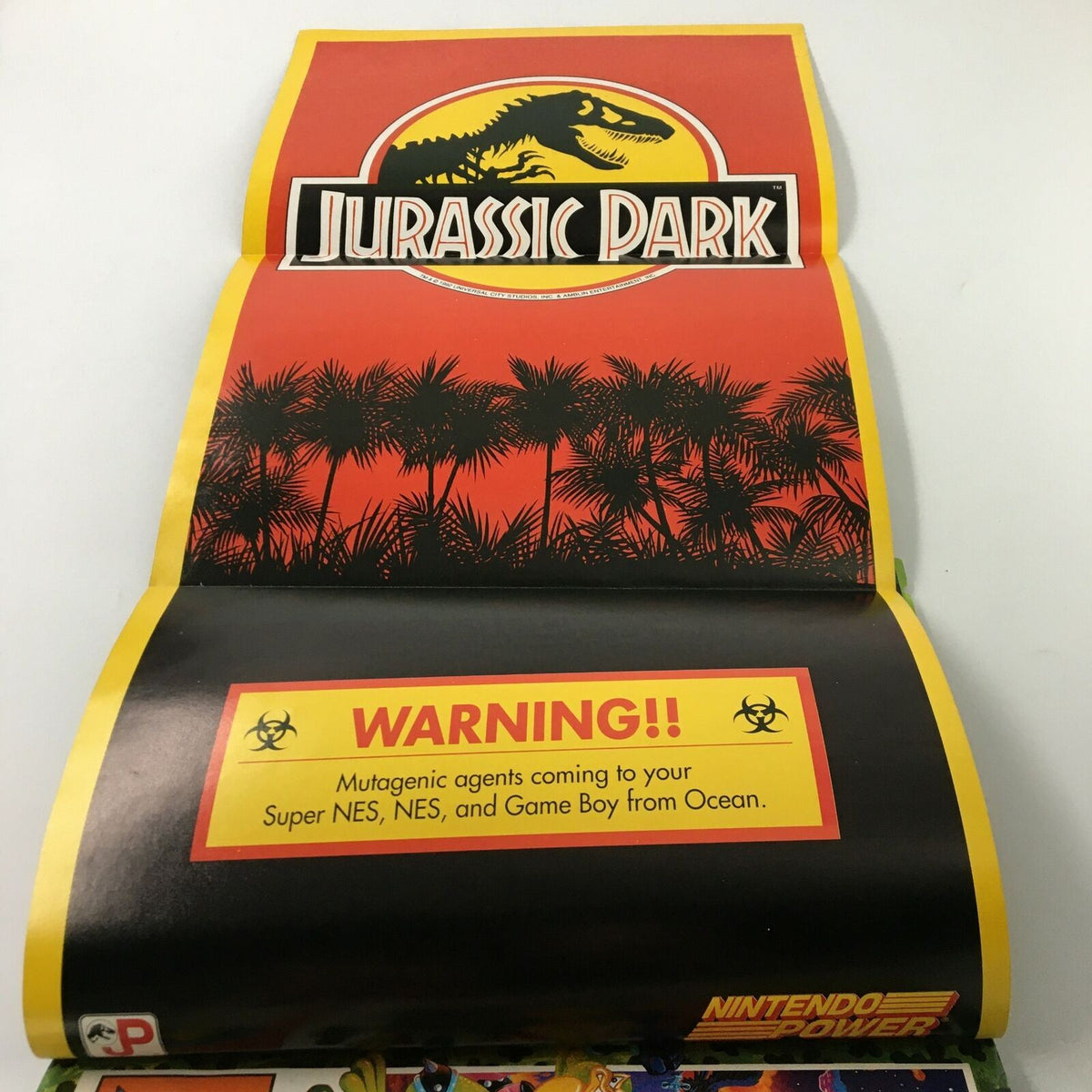 Fold-out poster from Nintendo Power Magazine June 1993 #49 featuring a vibrant Jurassic Park design with a warning message.