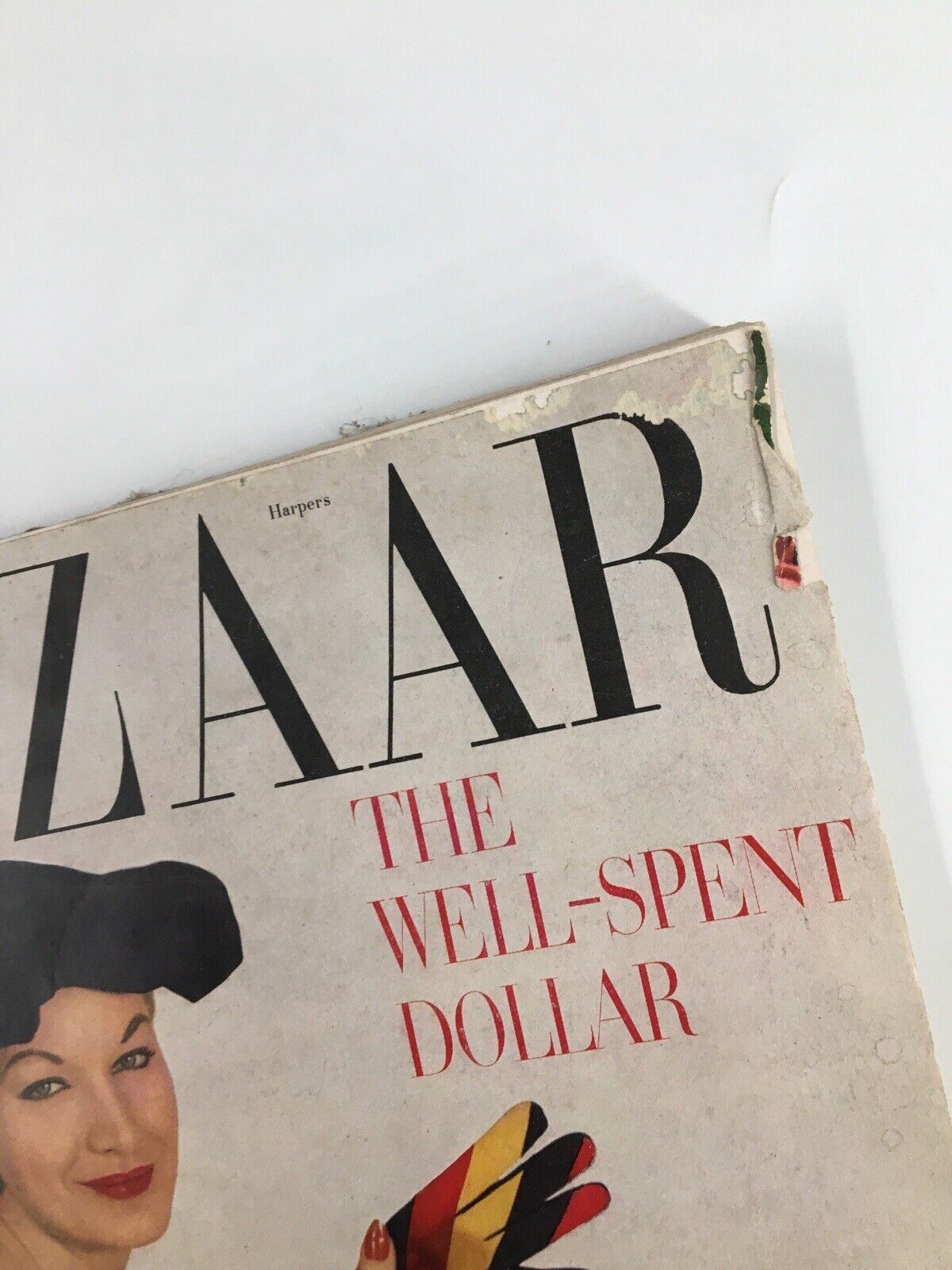 Cover detail of Harper's Bazaar Magazine February 1953 featuring vintage typography and a woman's portrait with gloves, showcasing mid-century fashion.