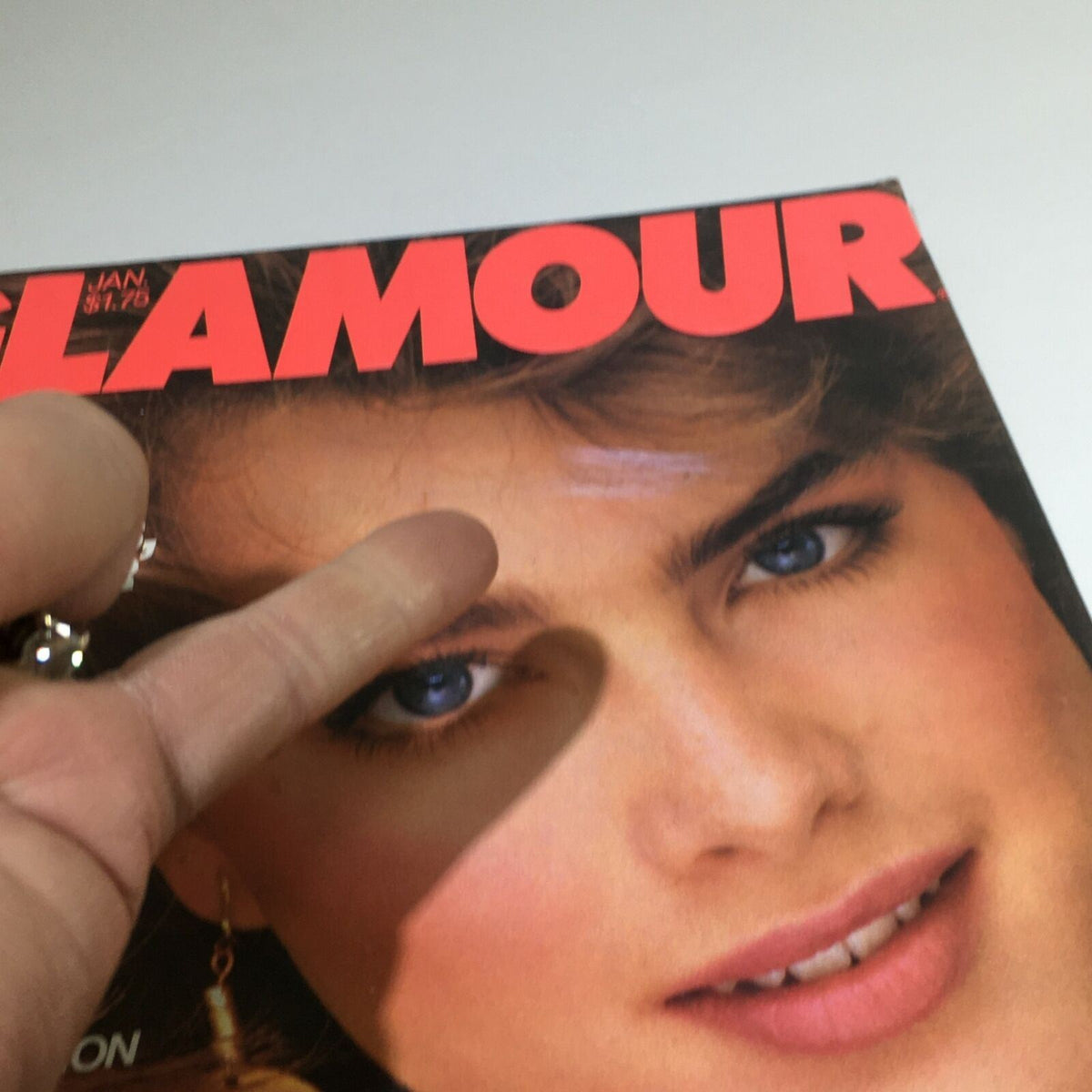 Close-up of the cover of VTG Glamour Magazine: January 1982 showcasing Brooke Shields, emphasizing the magazine's title and vibrant early 80s aesthetic.