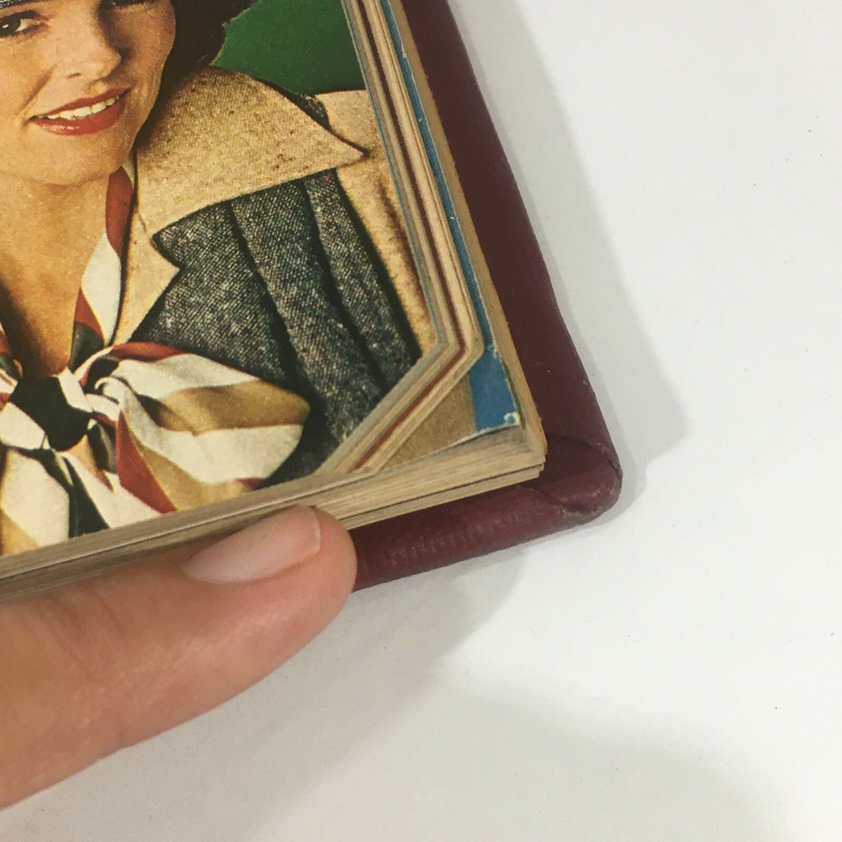 Close-up view of the side of the 1974 Woman's Day Magazine compilation, showing a woman's portrait in vintage fashion and the book's spine, illustrating its condition and unique style.