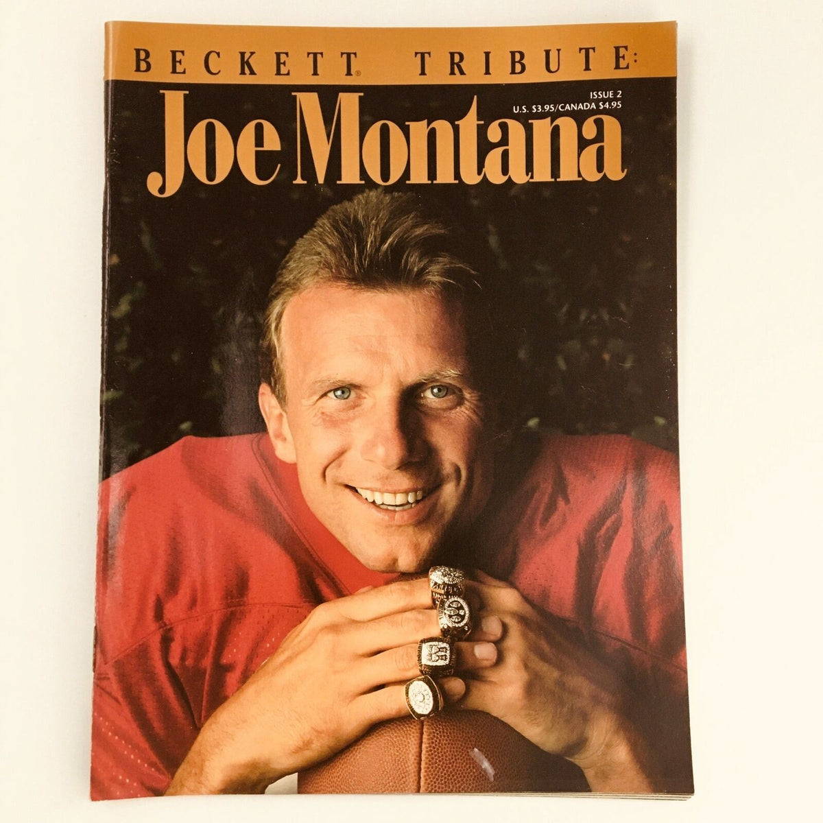 Beckett Tribute Magazine 1993 Issue 2 featuring Joe Montana on the cover, showcasing the NFL star smiling and displaying multiple championship rings.