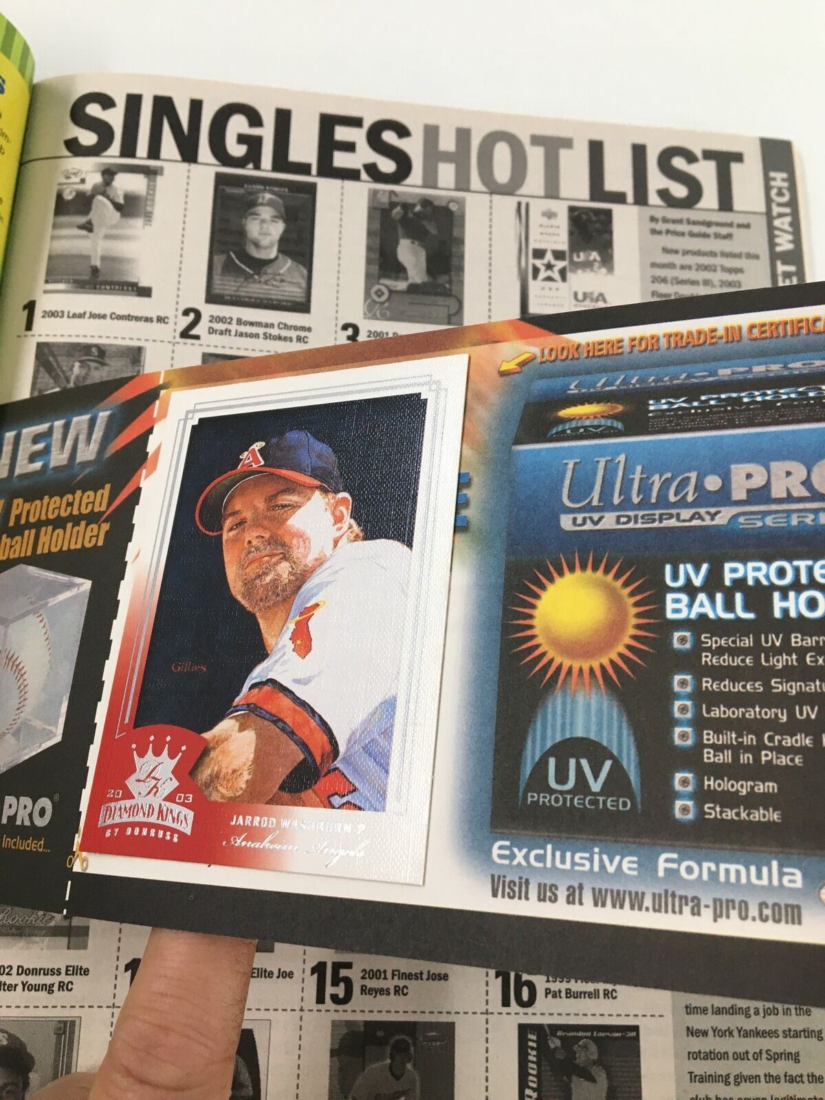Another page from Beckett Baseball Card Monthly April 2003 #217 highlighting singles hot list featuring Jared Weaver and UV protection details.