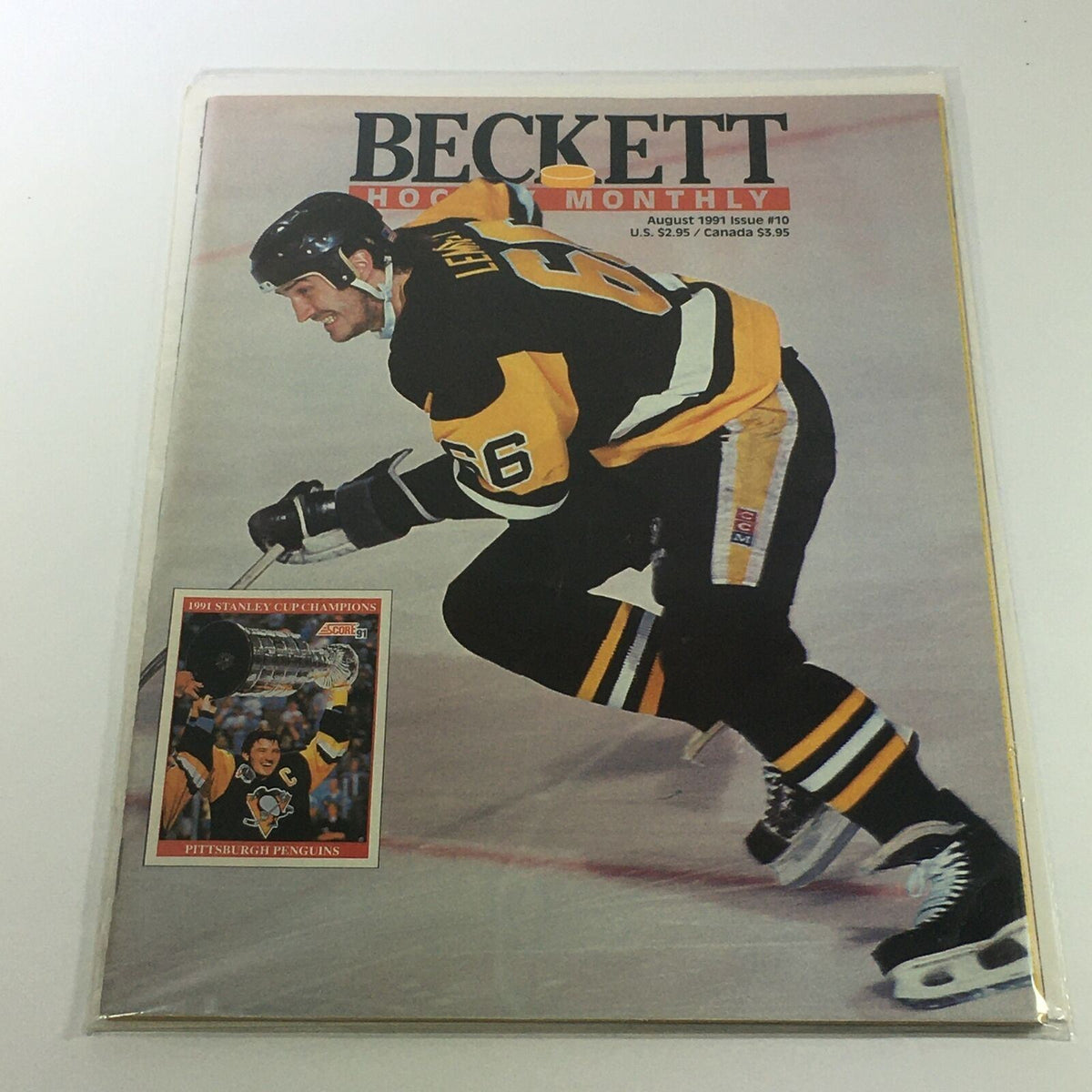 Beckett Hockey Monthly: August 1991 Issue #10 featuring Mario Lemieux on the cover. The magazine is in excellent condition, bagged and boarded in plastic covering.